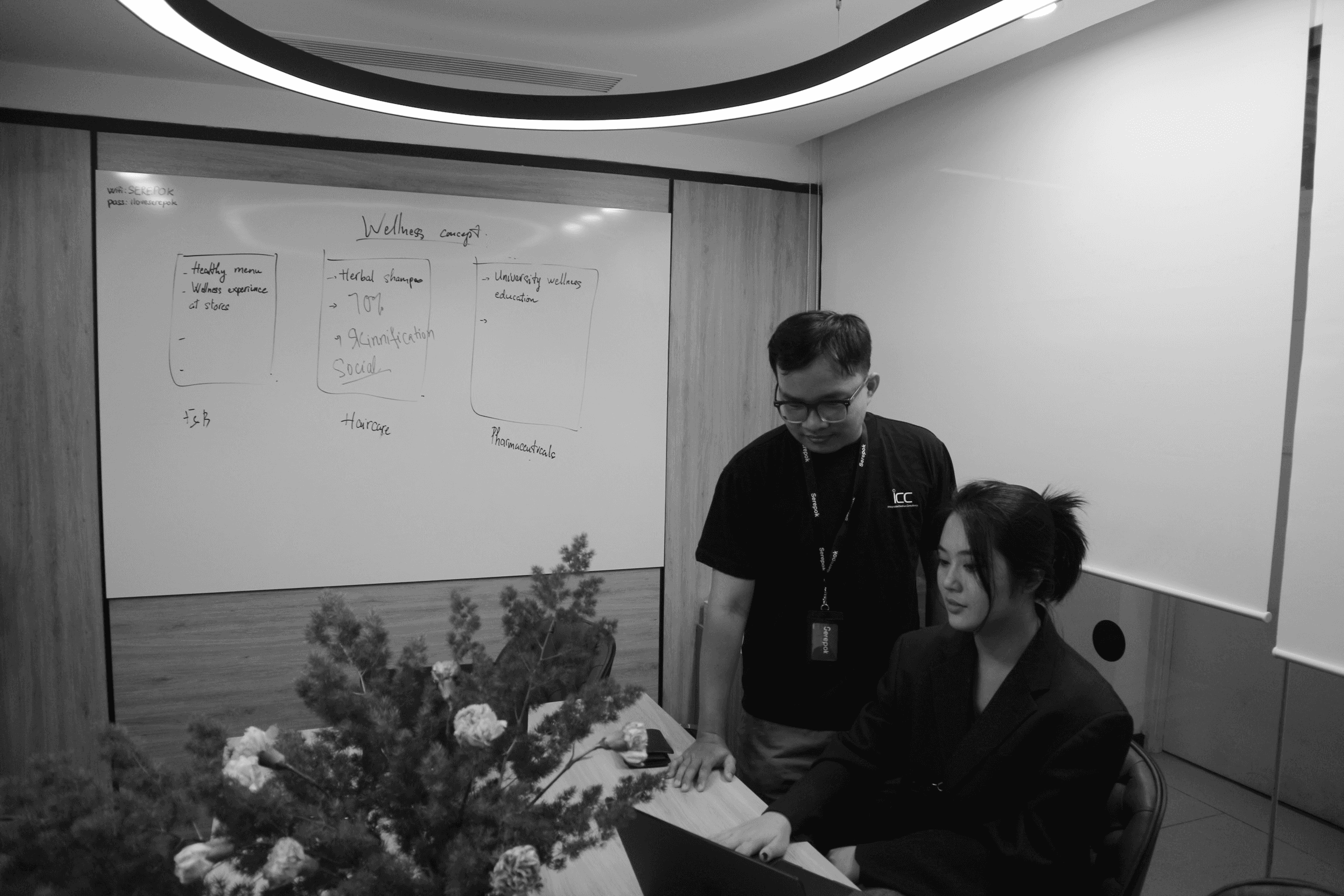 grayscale photo of person using MacBook