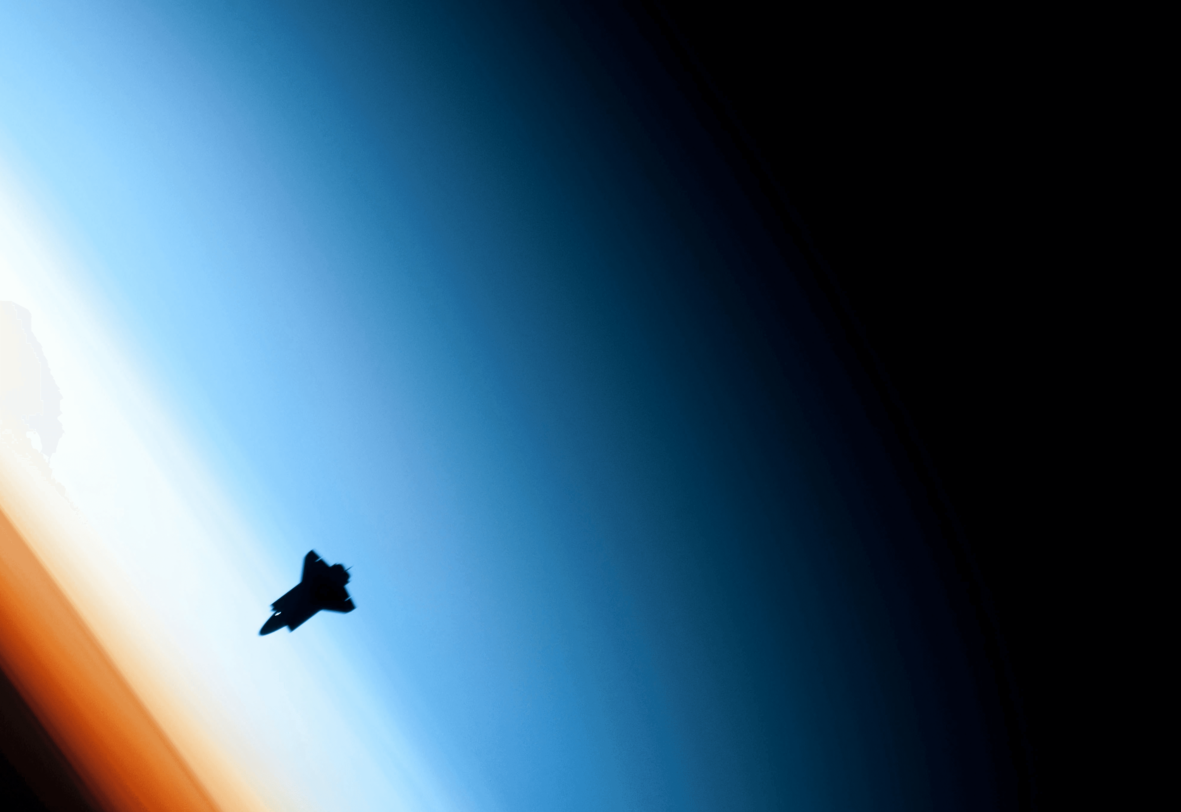 Space Shuttle orbits above earth atmosphere