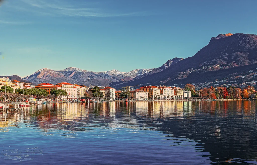 View of Lugano with lake and mountains, where the Riva Atelier showroom showcases italian luxury furniture and contemporary design.