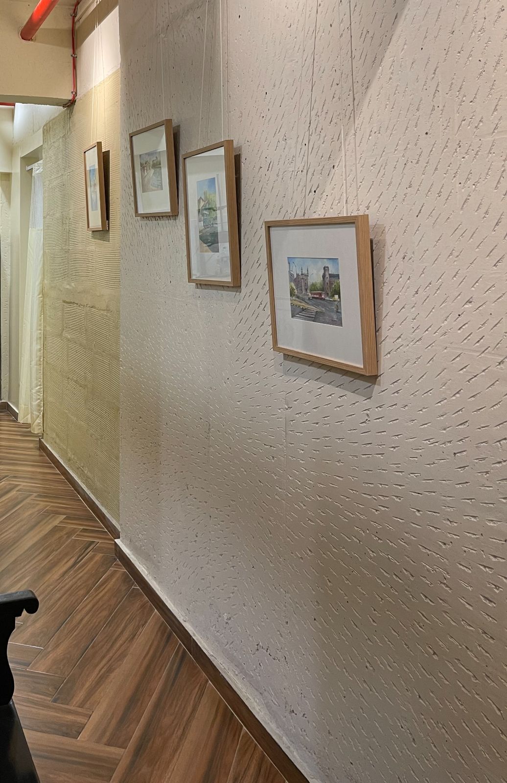 Nature-inspired preschool entrance with sculptural tree partitions and suspended green leaf ceiling panels.