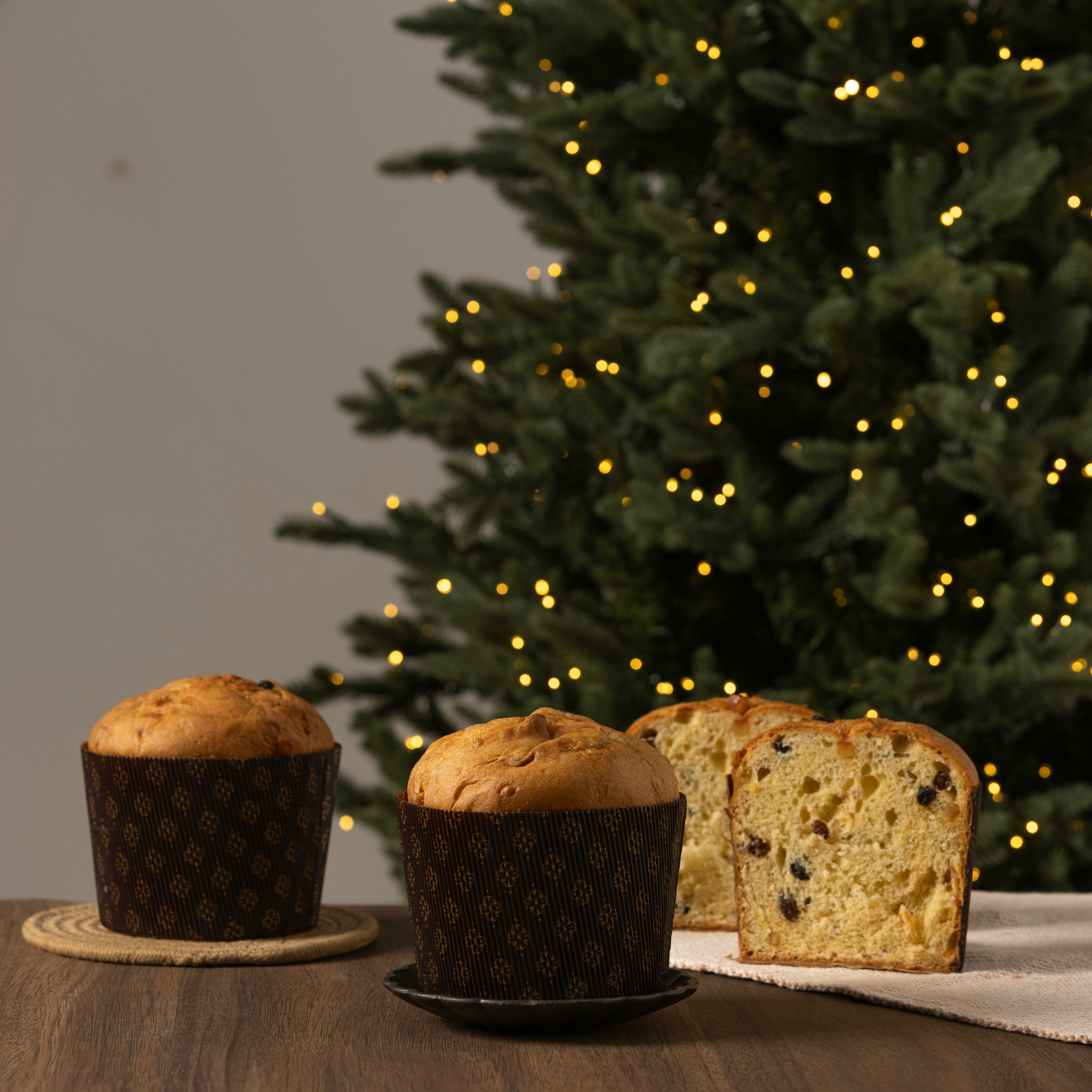 Two panettone cakes with a sliced one.