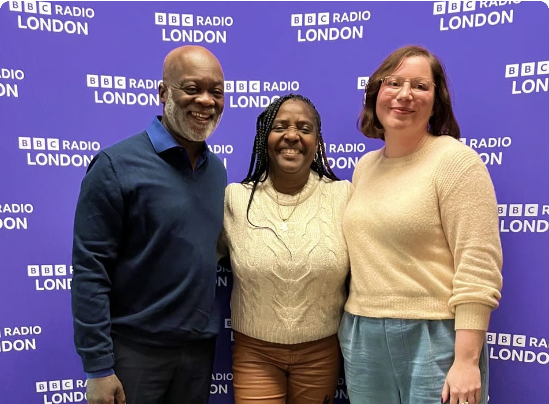 Charlotte Newman, Eddie Nestor and a carer posing in front of BBC radio London screen
