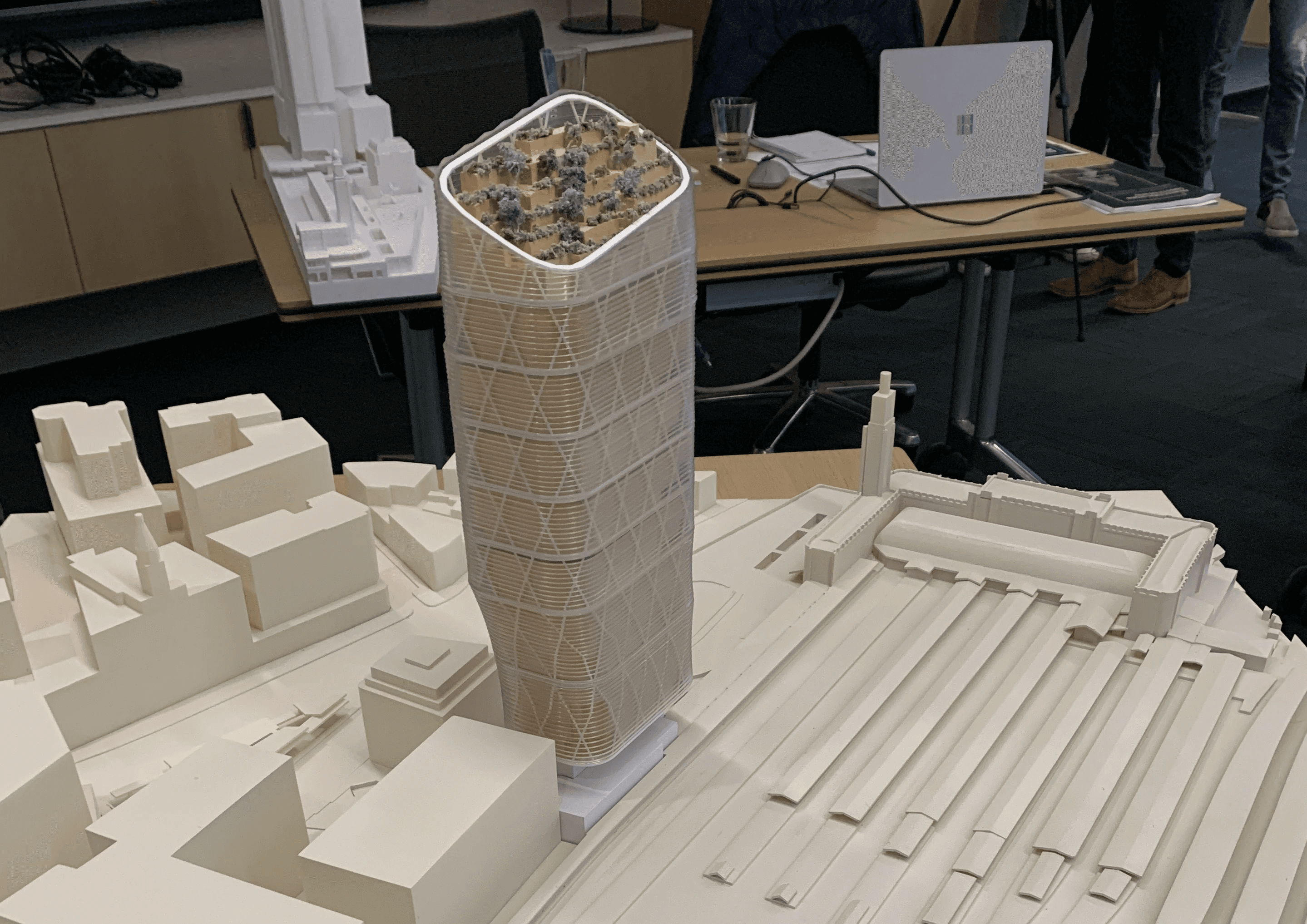 white concrete spiral staircase with brown wooden wall