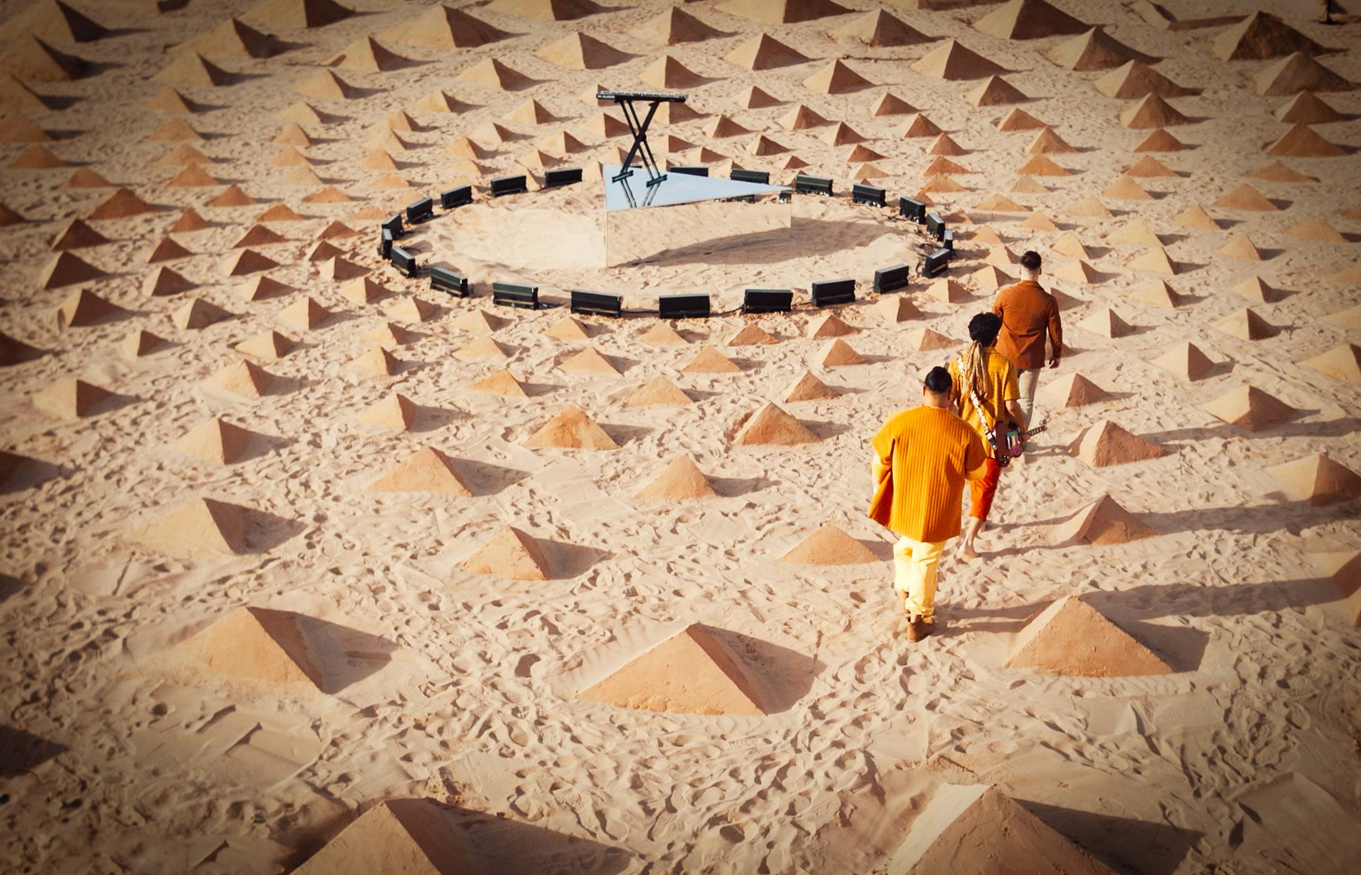 The band ARIZONA walking through land art while filming a music video for the song “Moving On” directed by Owen Brown