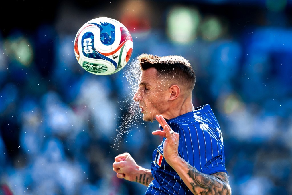 A France player wins a header with sweat flying during the 2026 World Cup Round of 16 against Paraguay