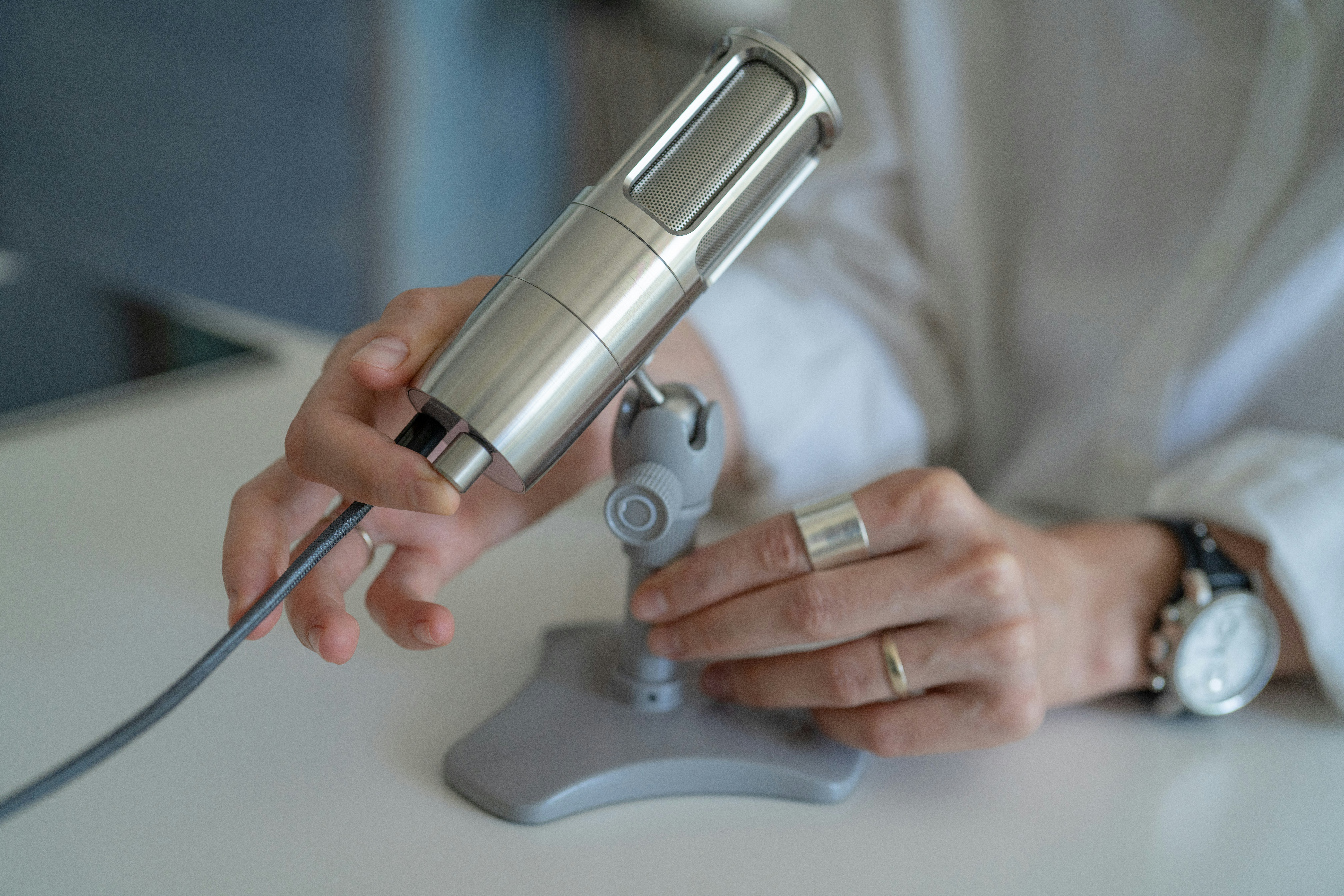 woman adjusting her mic - How To Make An AI Voice Model