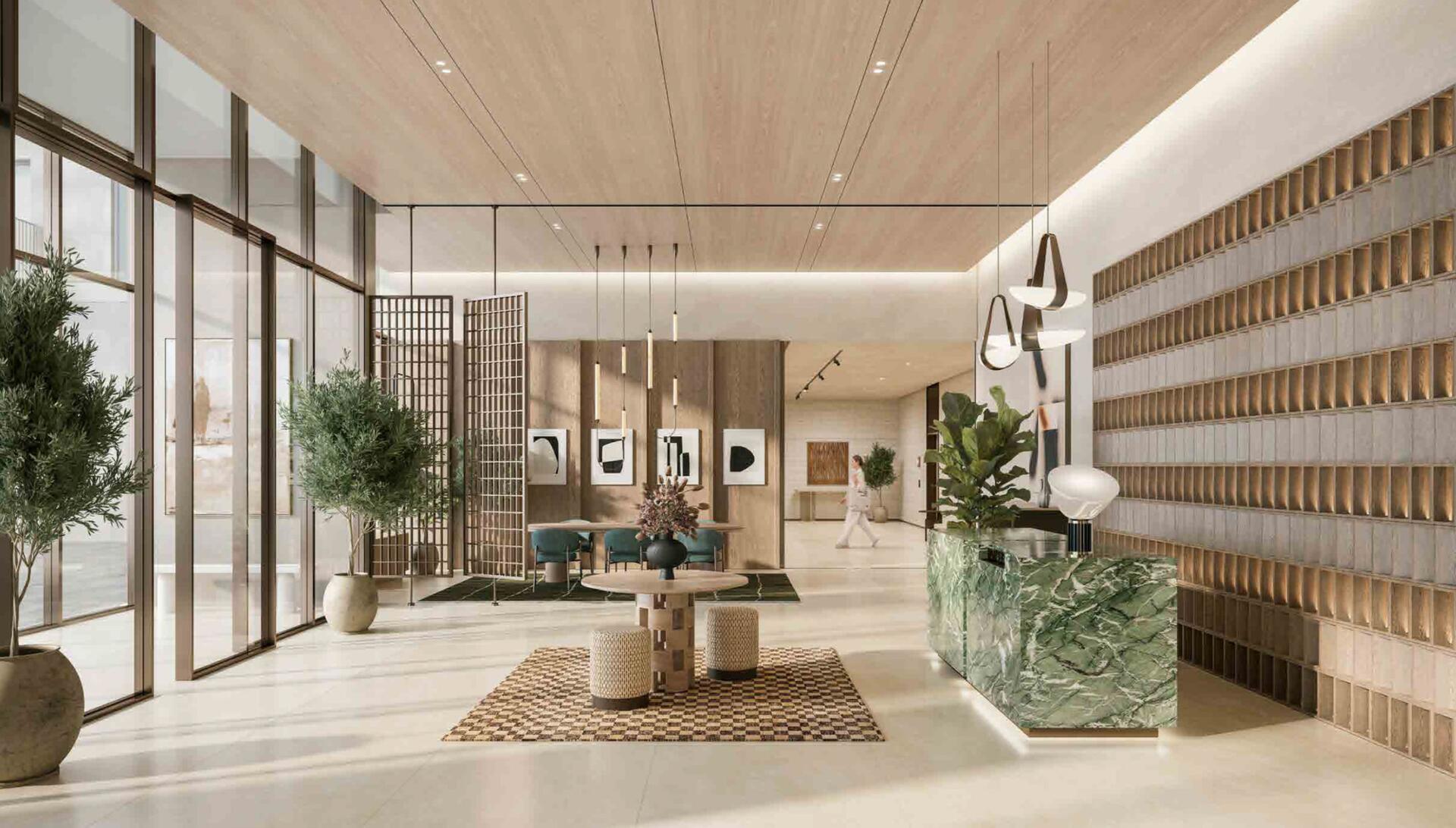 Modern apartment building lobby featuring sleek furniture and contemporary decor, with large windows allowing natural light.