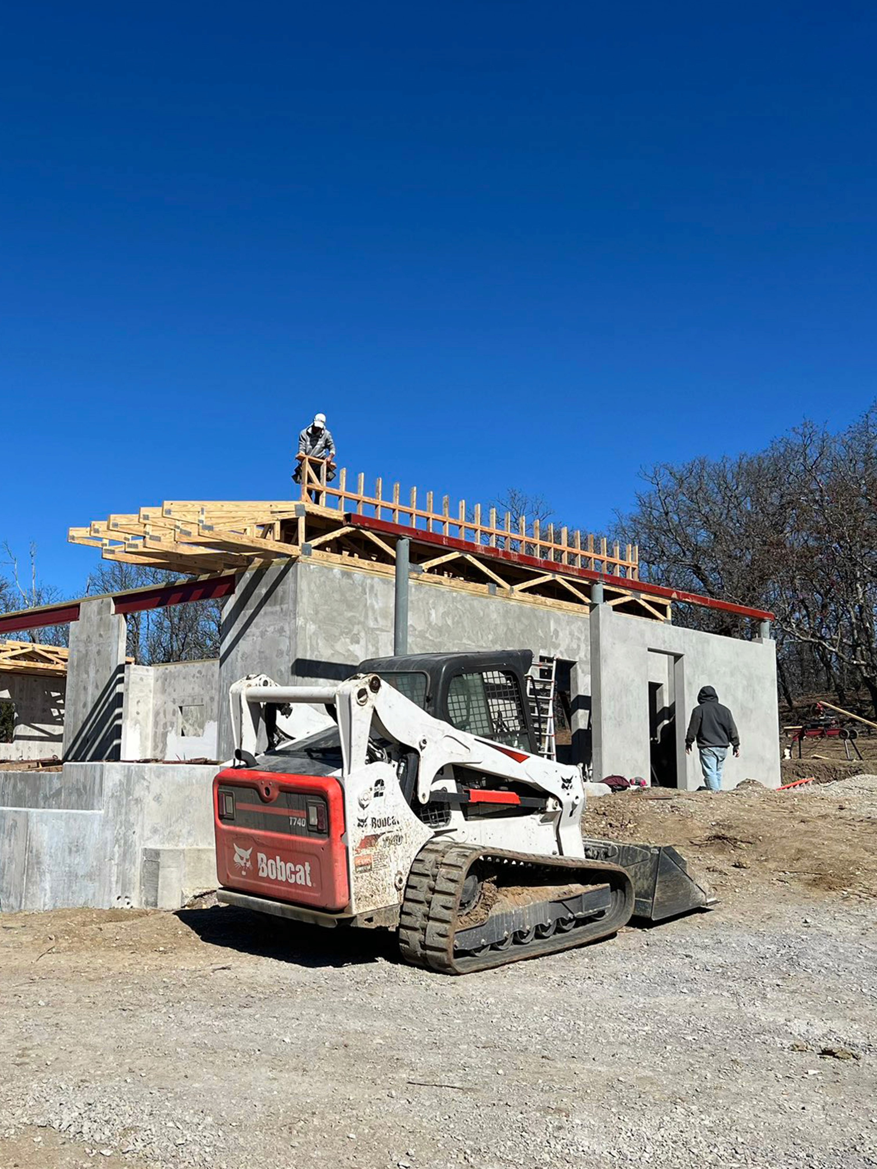 concrete house constructio with bobcat