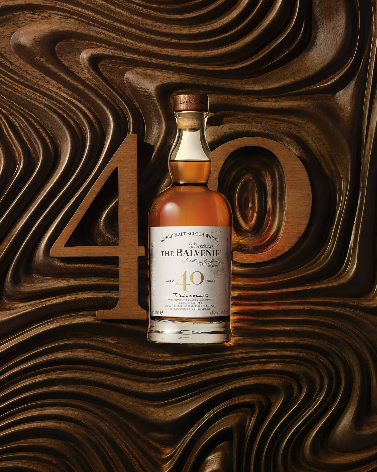 A bottle of whiskey is placed against a textured wooden background featuring wavy patterns.