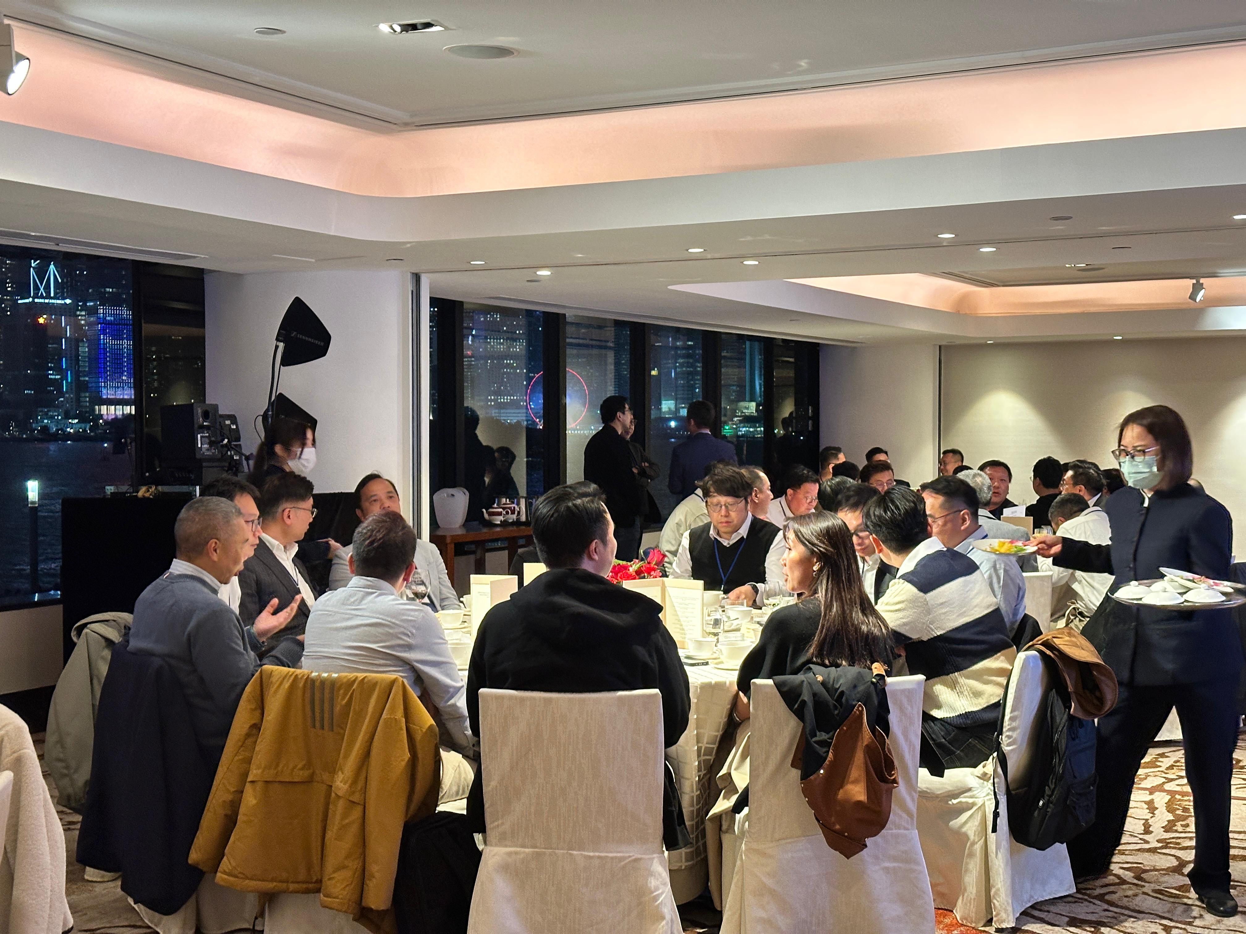 Elegant corporate annual dinner with professional wine pairing, beautifully set table featuring gourmet food and premium wines.