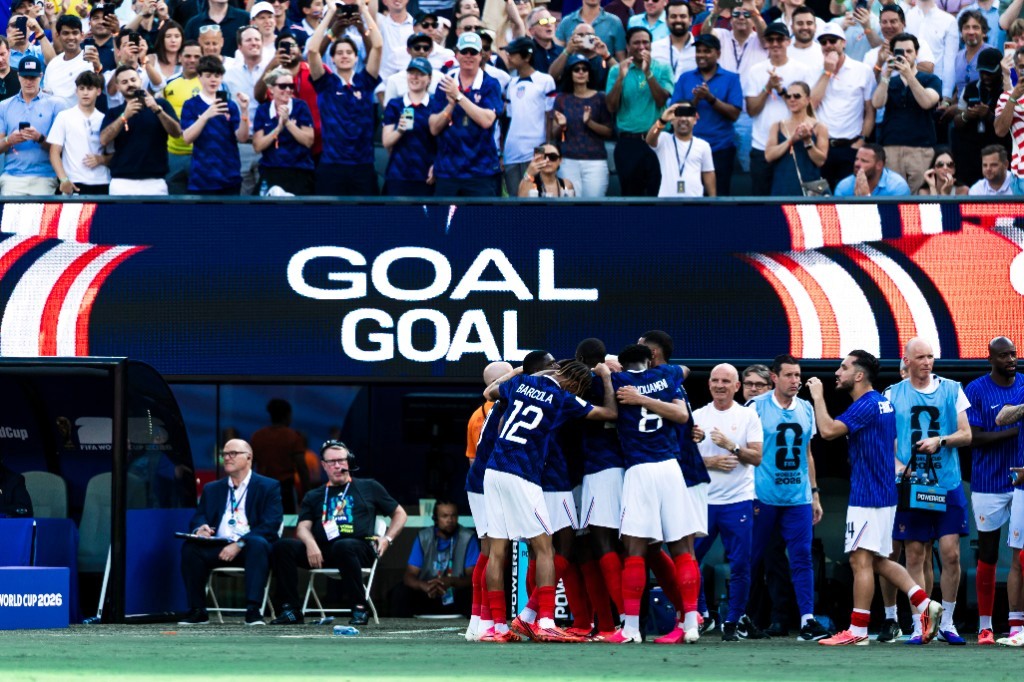 Bradley Barcola and Aurélien Tchouaméni celebrate a France goal under a GOAL board at World Cup 2026