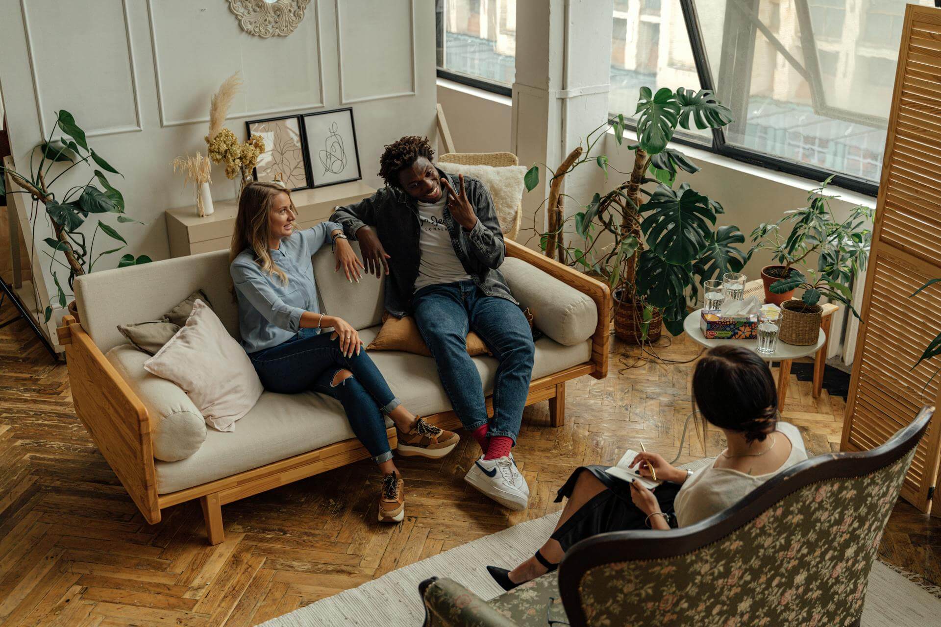 a group of people sitting on sofa and smiling