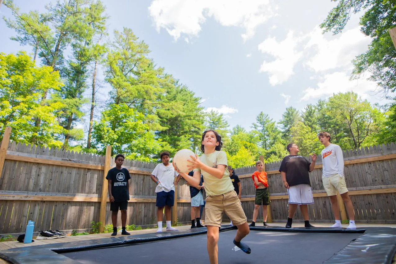 Campers and counselors walking together on the camp grounds at Camp Lenox