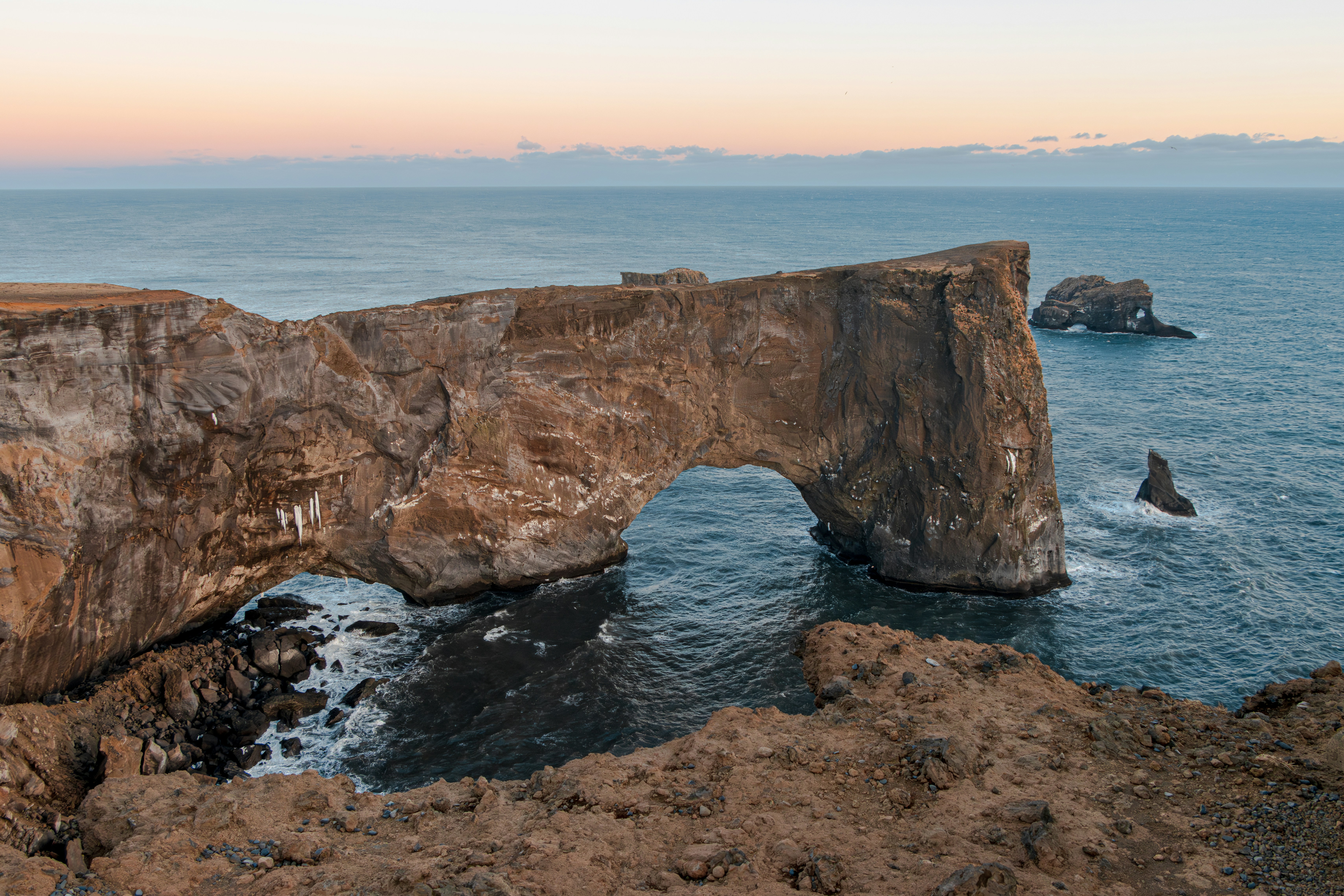 Dyrhólaey rock arch under a dusky sky in South Iceland.