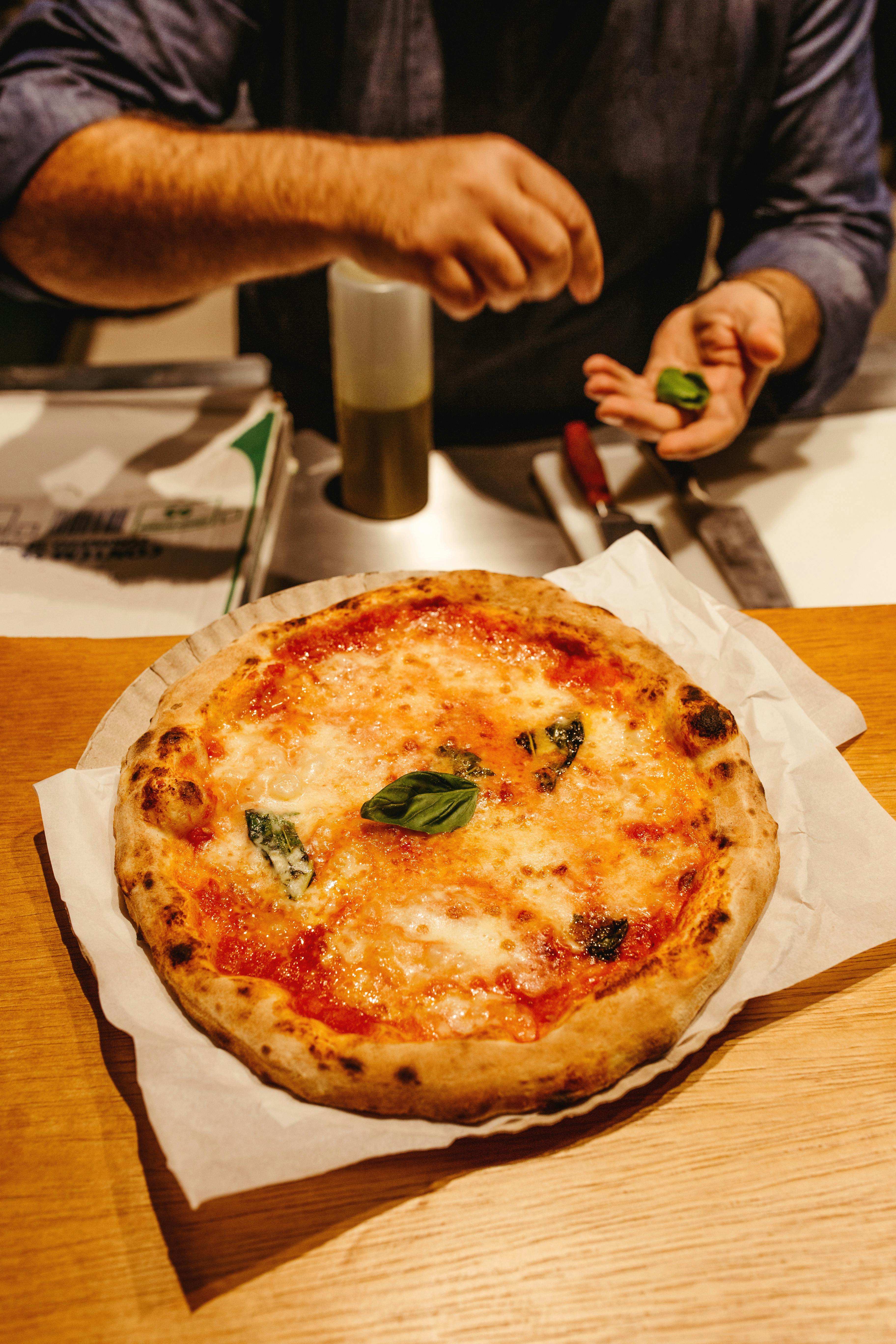 Two colleagues smiling and collaborating at a laptop in a bright office.