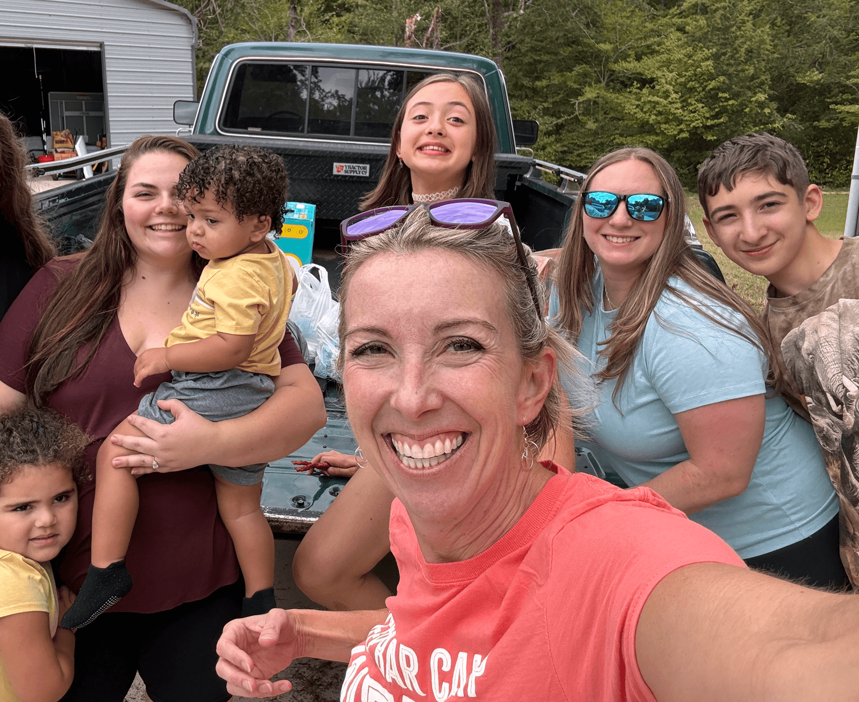 Leigh Brown of Patriot Relief stands with a group of volunteers and donation recipients