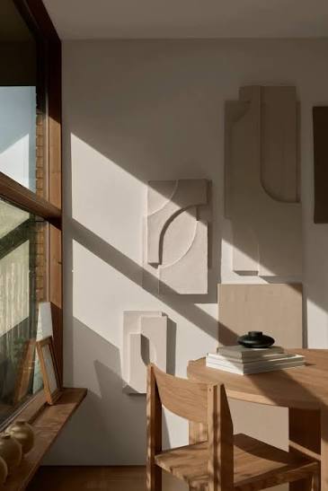Wall art and a chair by a window