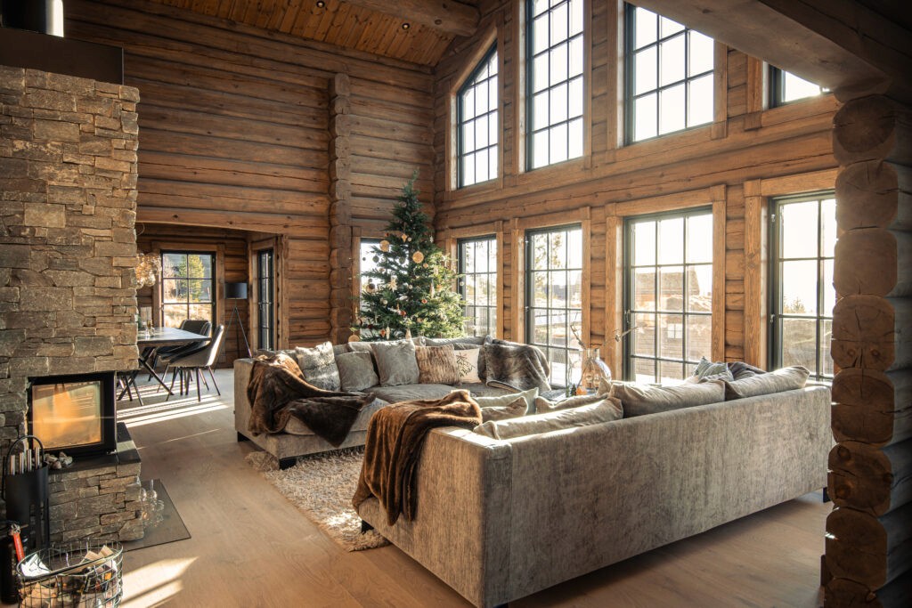 Open-concept living area in a log cabin at Idre Himmelfjäll with panoramic windows and natural light.
