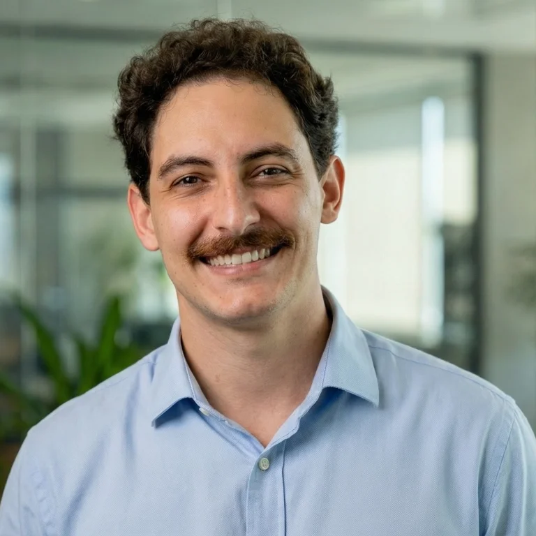 a man standing in front of a purple wall