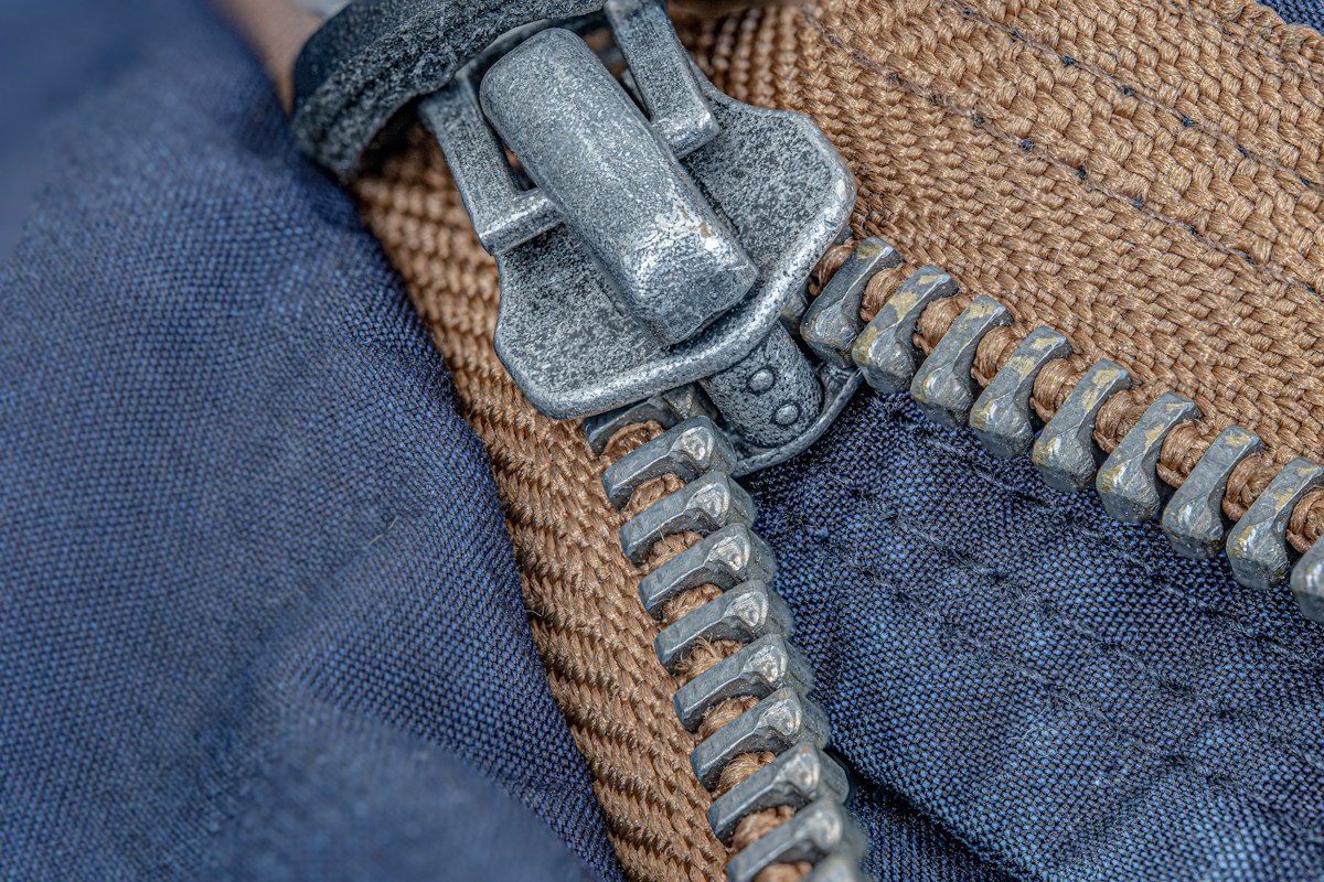 A heavy brass zip on a denim jacket