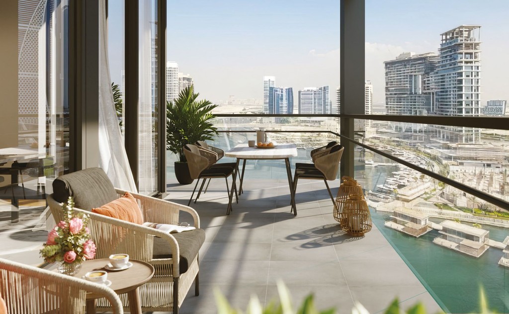 A balcony at The Crestmark featuring chairs and a panoramic view of the city skyline.