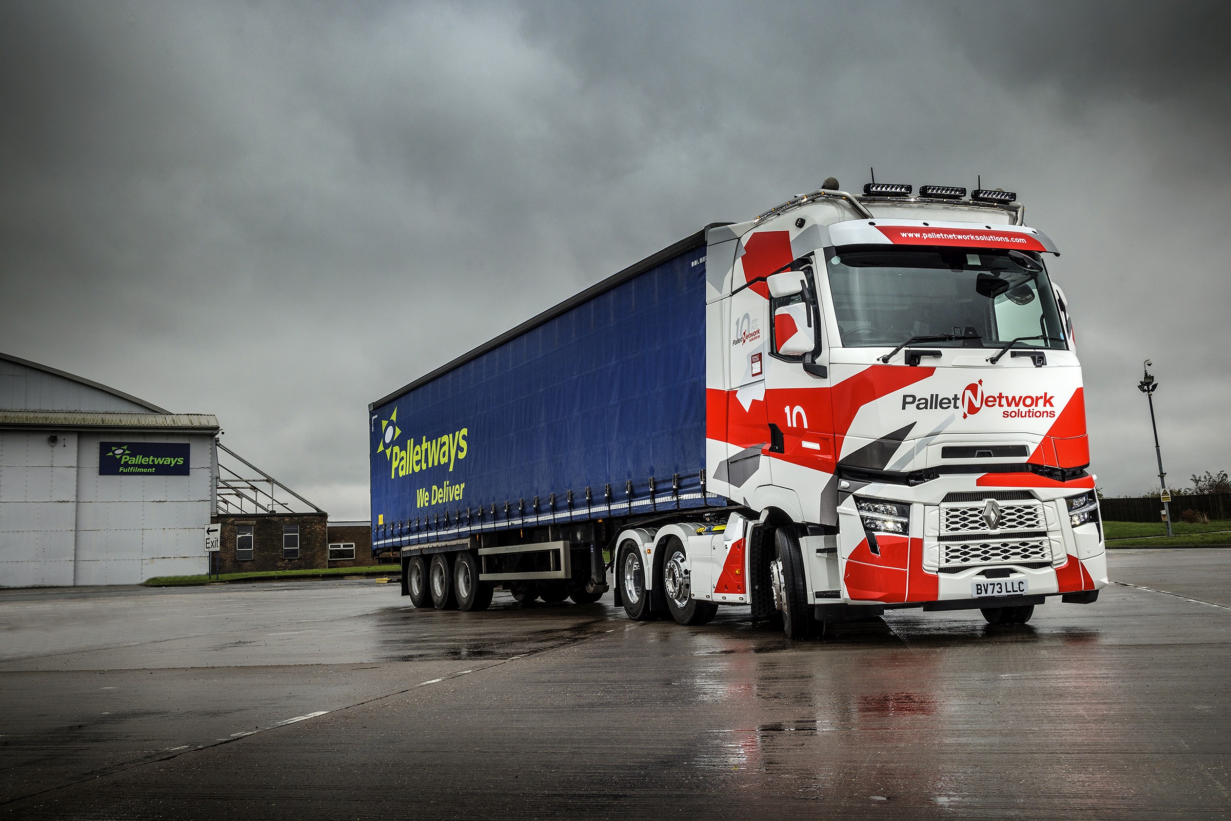 Pallet Network Solutions truck pulling a Palletways trailer in a fulfillment center