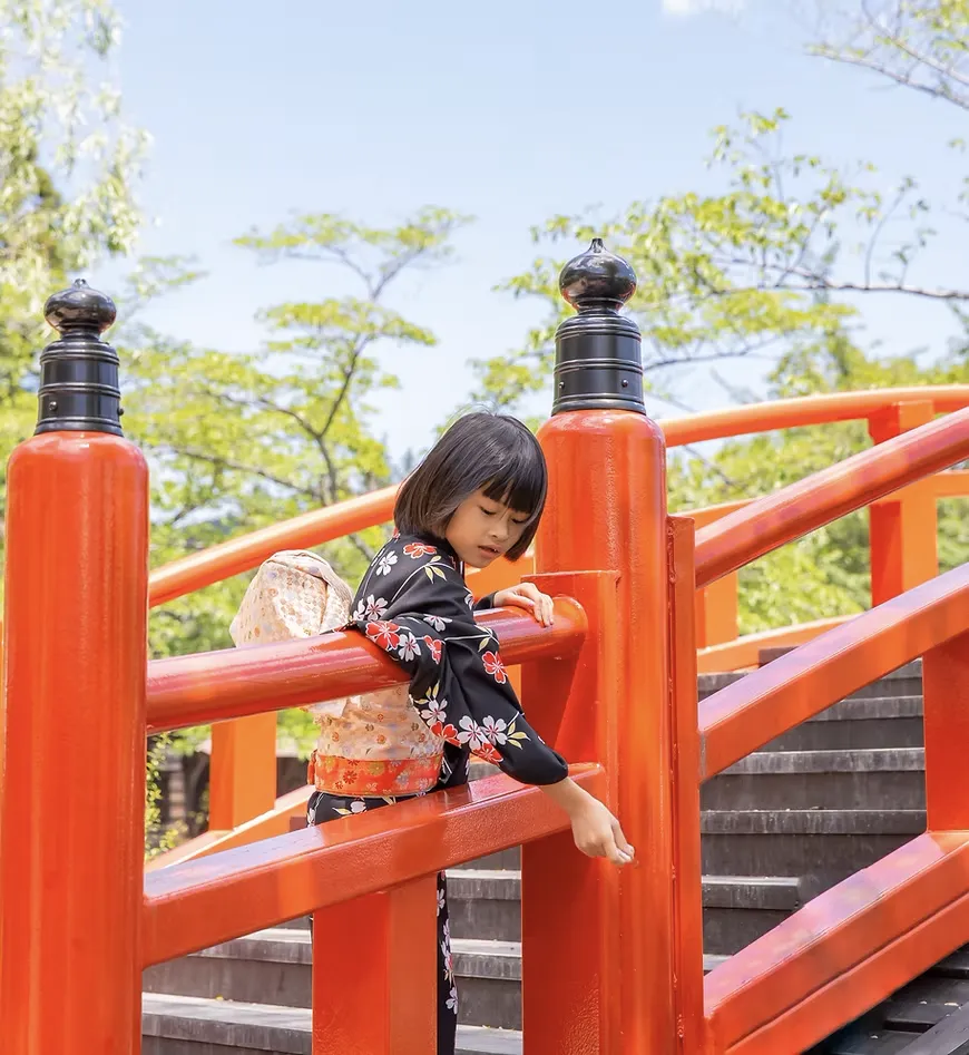 Child in kimono on red bridge for Japan360