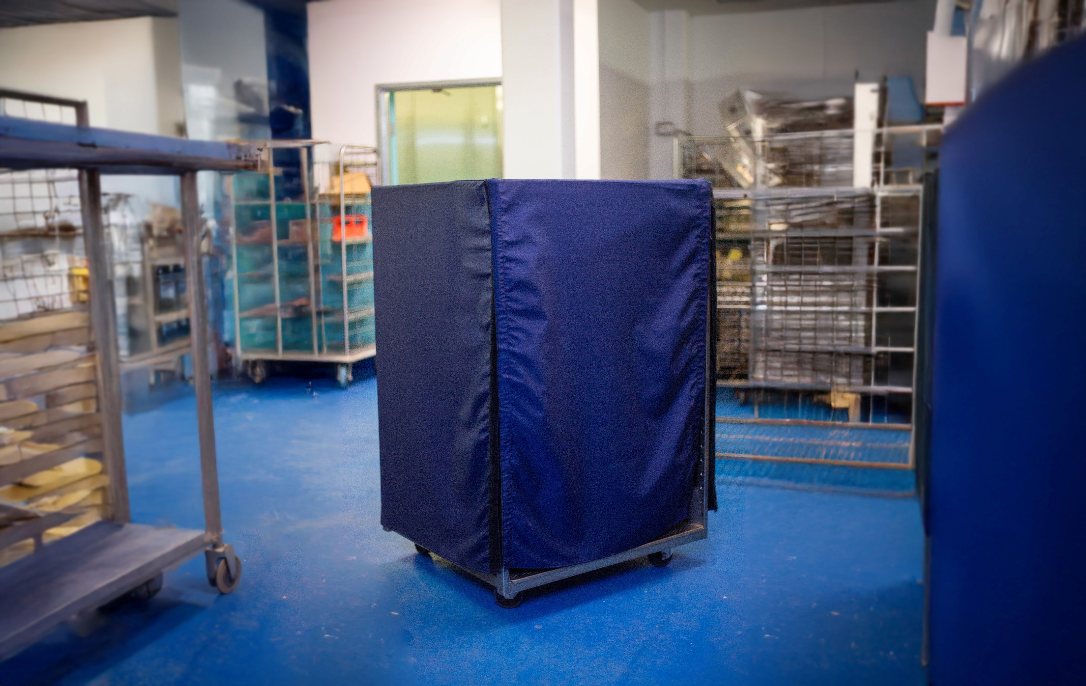 Blue autoclave equipment cover made from ripstop nylon, used in sterile manufacturing environments to prevent contamination.