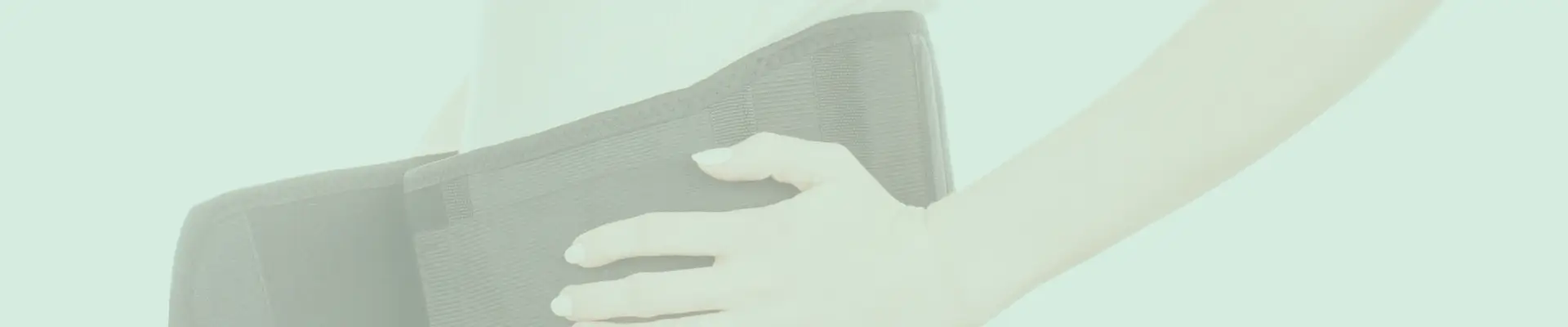 Close-up of a postpartum belly support band being worn, providing compression and back support for new moms.