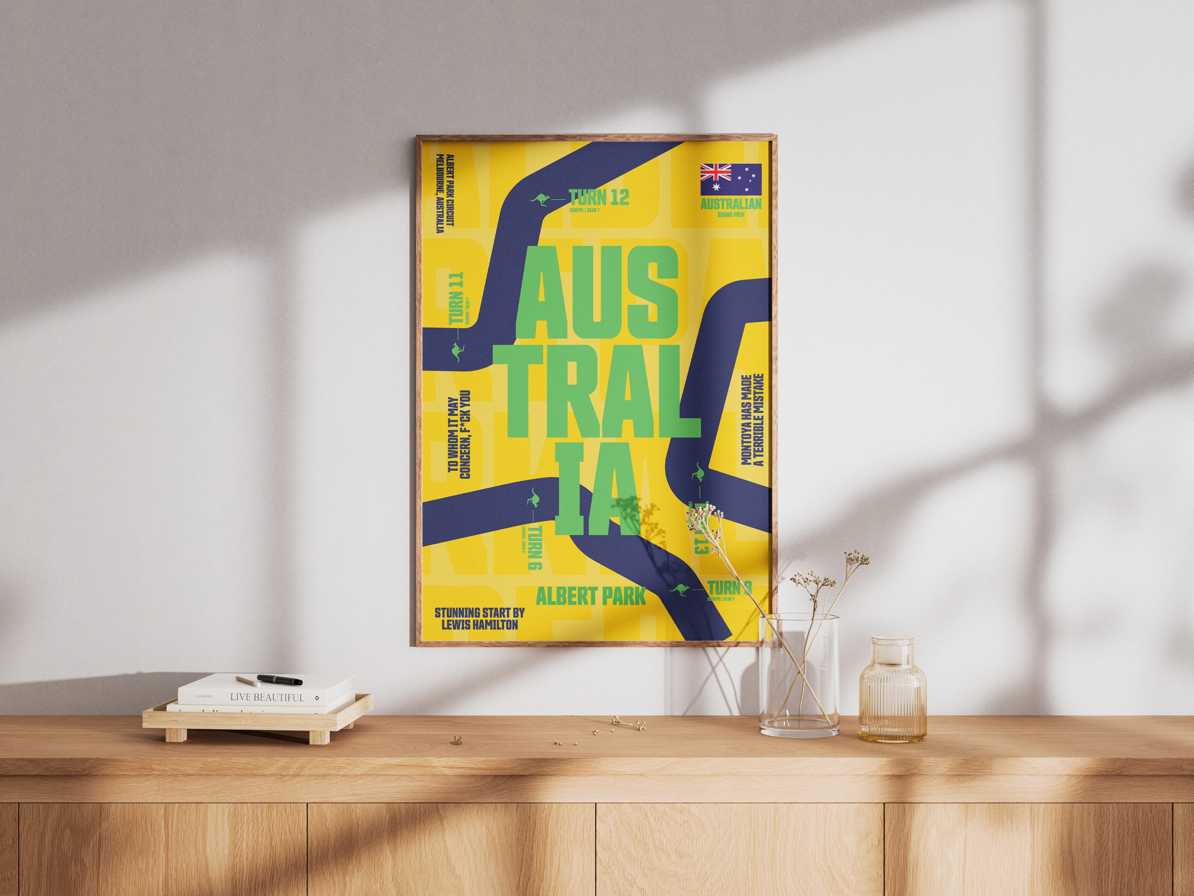 Person wearing black clothing carrying a black tote bag with a green globe-like geometric symbol, standing against a concrete wall in sunlight and shadow.