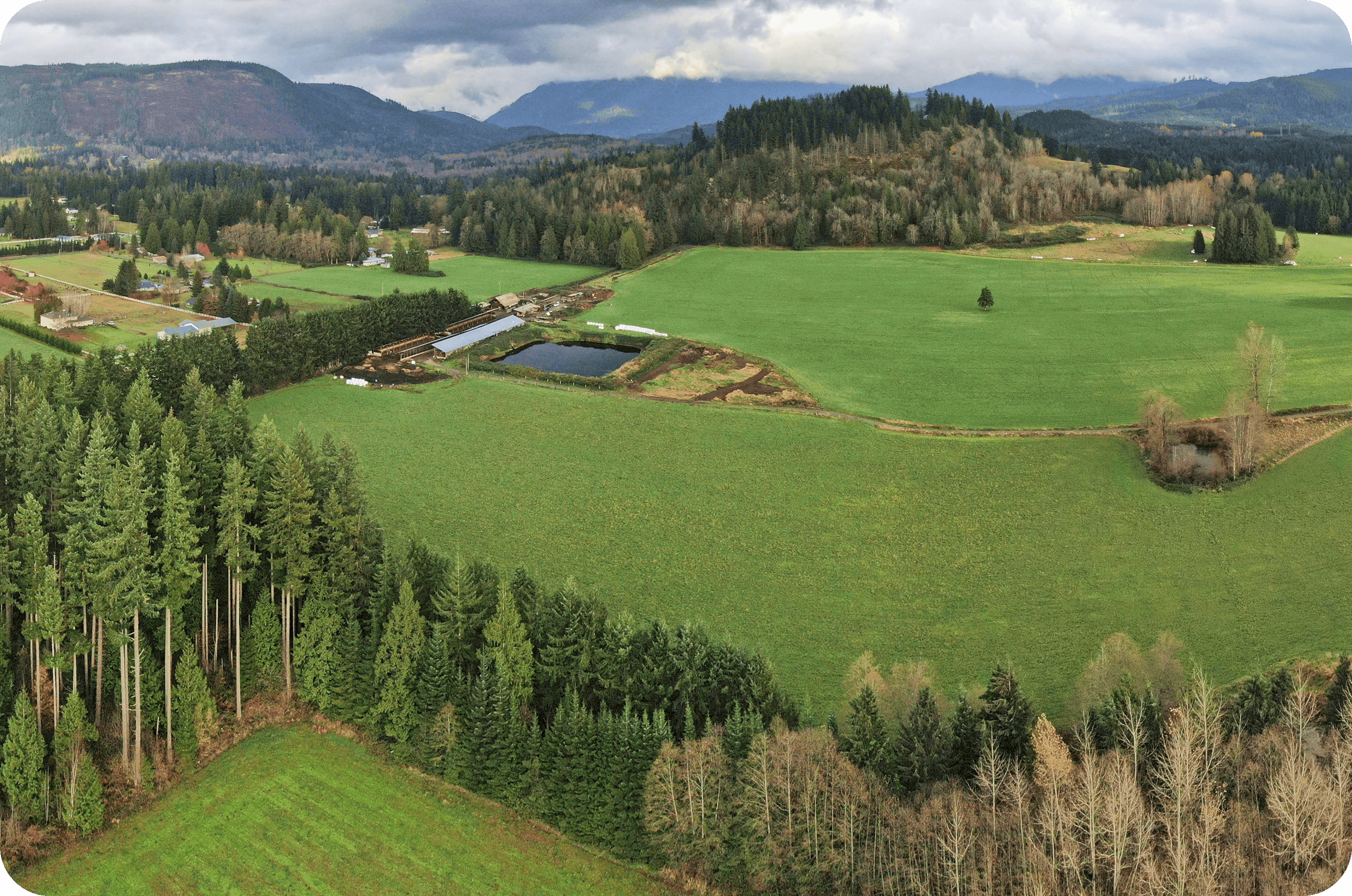 Community members gathered together indoors in conversation during a cohousing meeting.