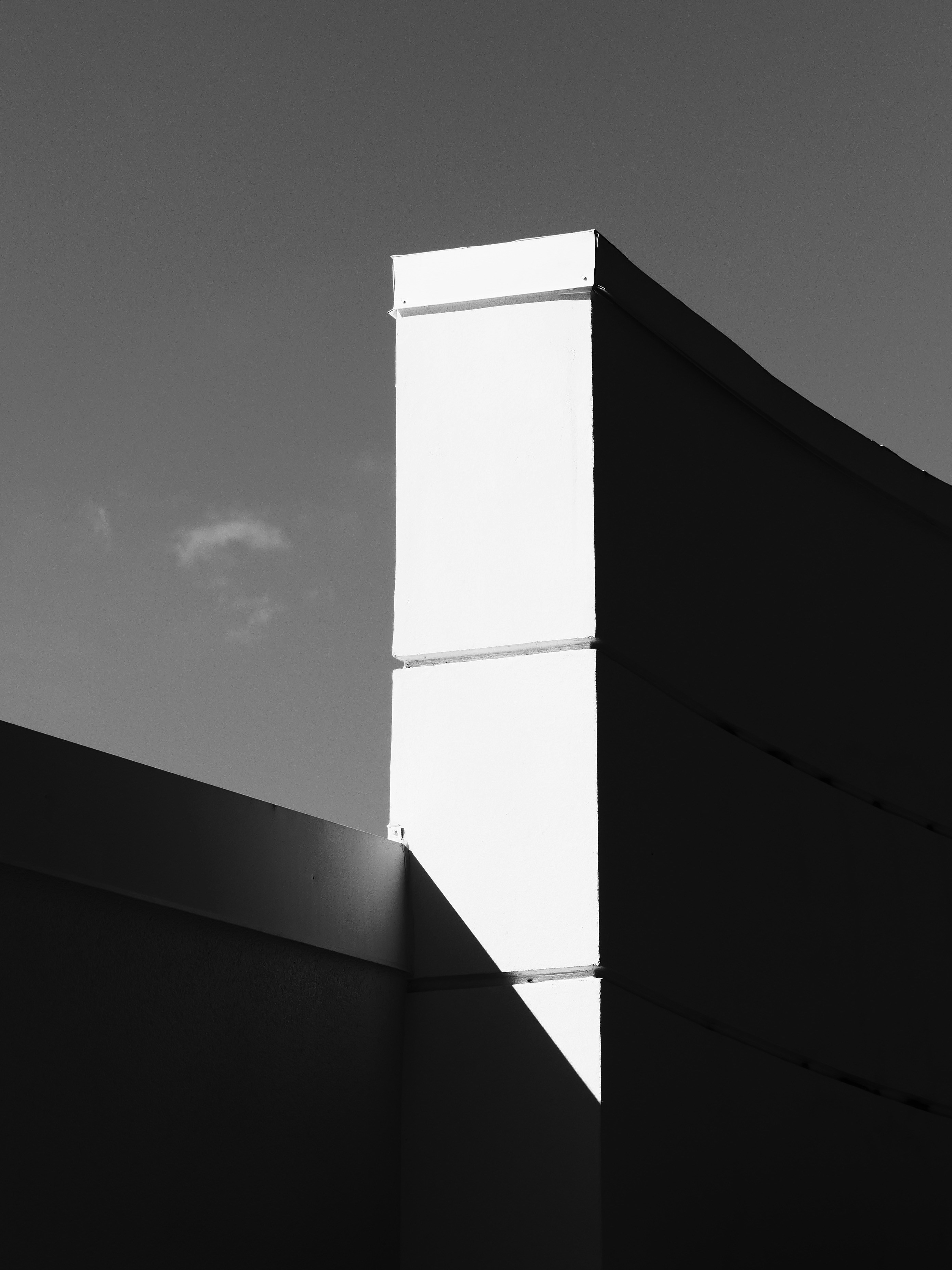 Modern building exterior with strong geometric shadows.