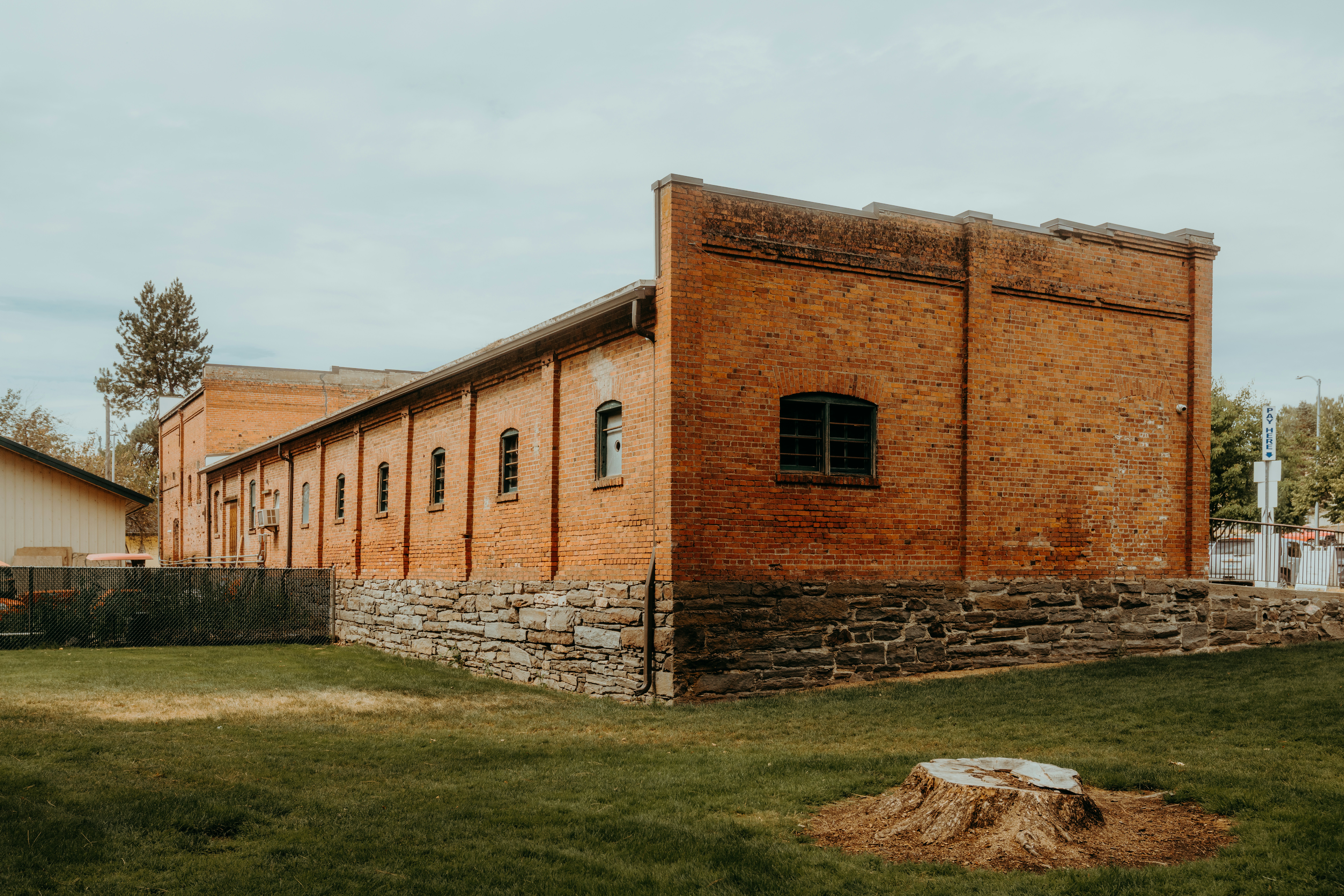 An old brick warehouse beside a field