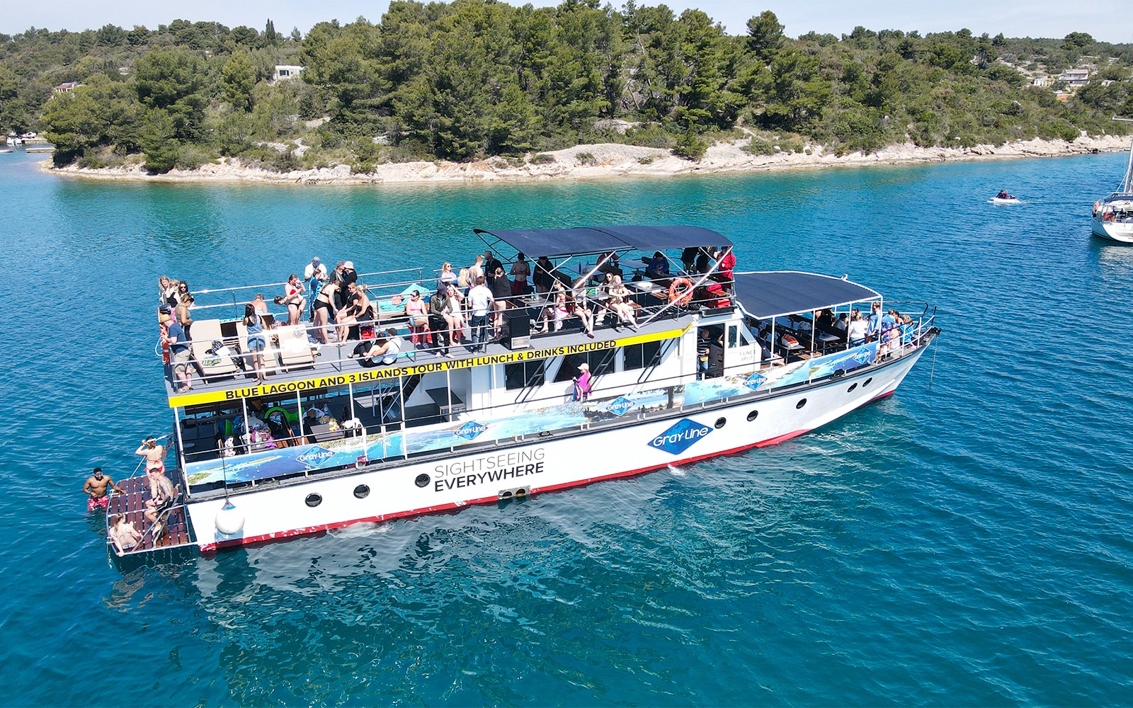 Cruise ship with tourists on Blue Lagoon tour near Split, Croatia.