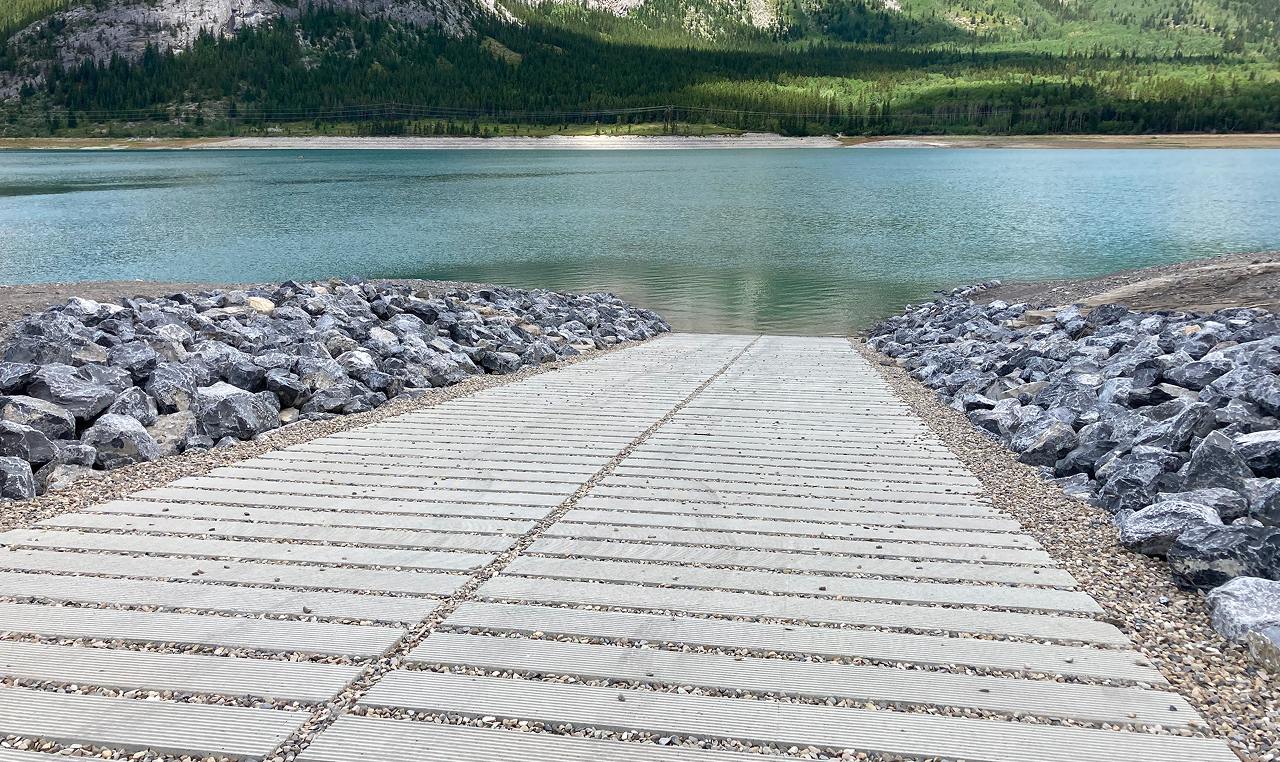 Precast concrete boat ramp panels with riprap armoring at Barrier Lake in Kananaskis
