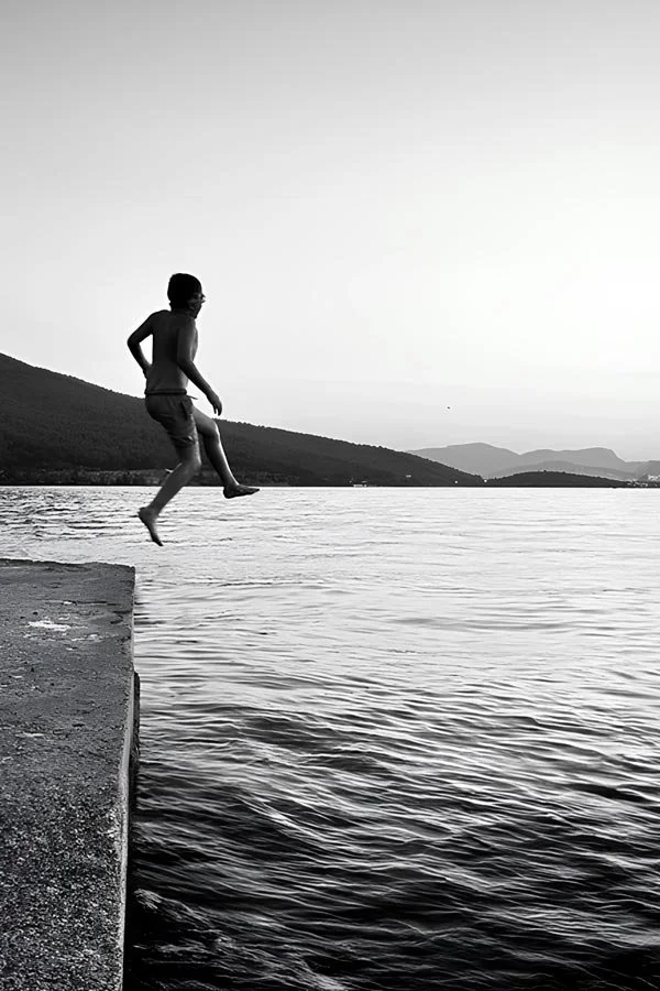 Boy jumping into a lake in  on a lake in Bodrum Turkey