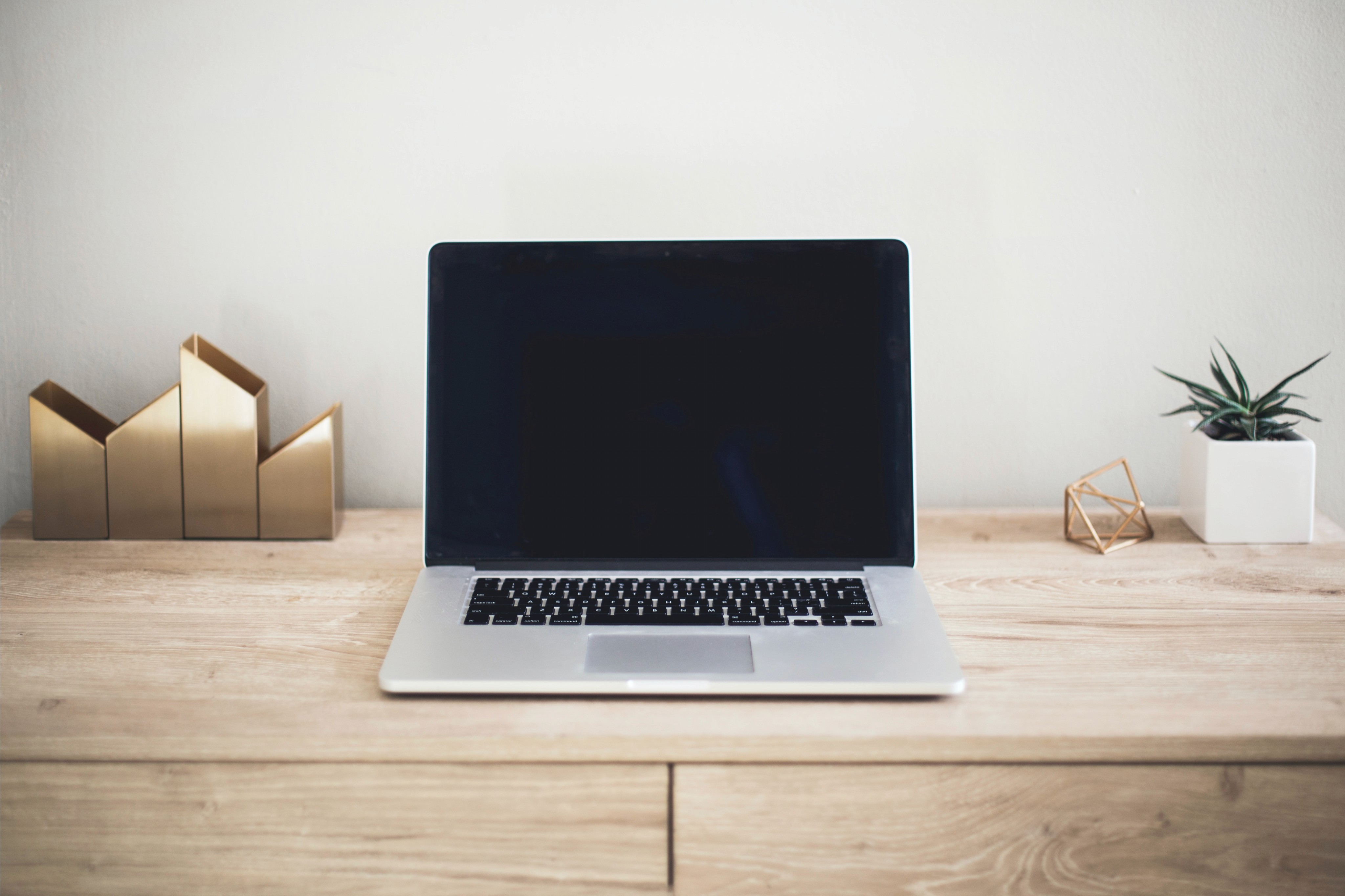 Latop on a minimal woodgrain desk