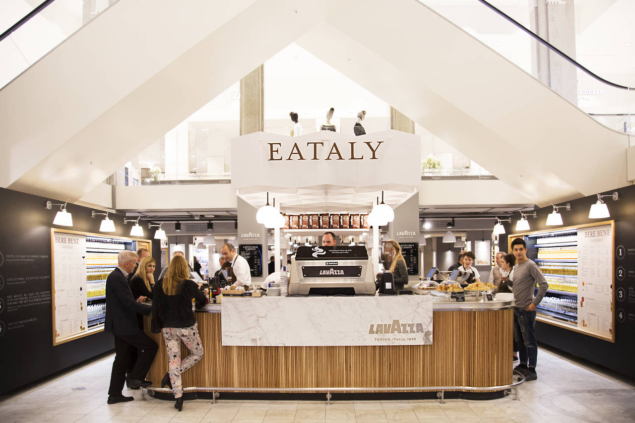 Eataly Alti Cibi location exterior showcasing modern architectural design with marble aesthetics and premium positioning in urban setting - multi-market brand presence and geo-localized media strategy developed by Alessandro Brancati Marketing & Growth Studio