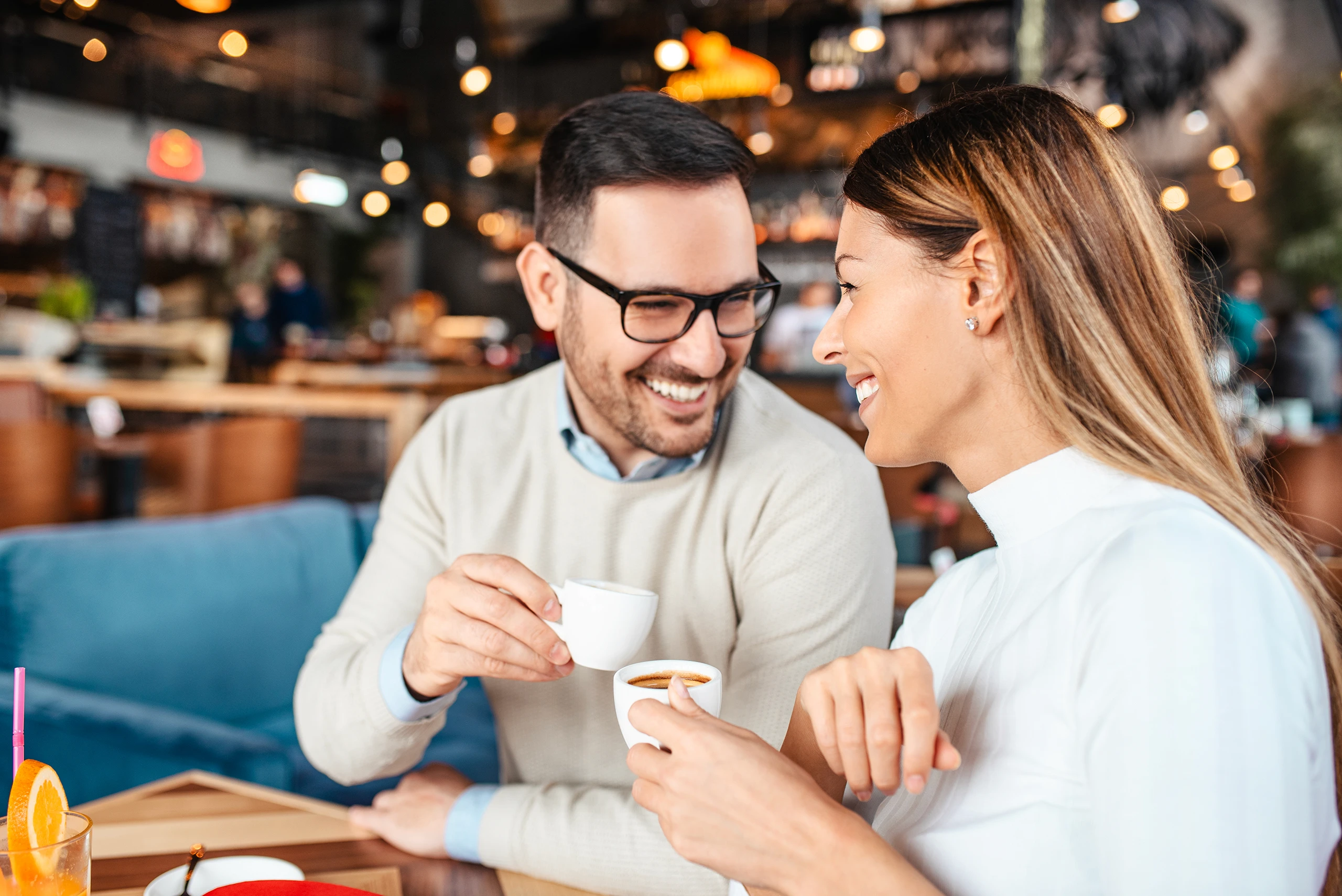 Couple enjoying coffee and conversation in a cozy cafe