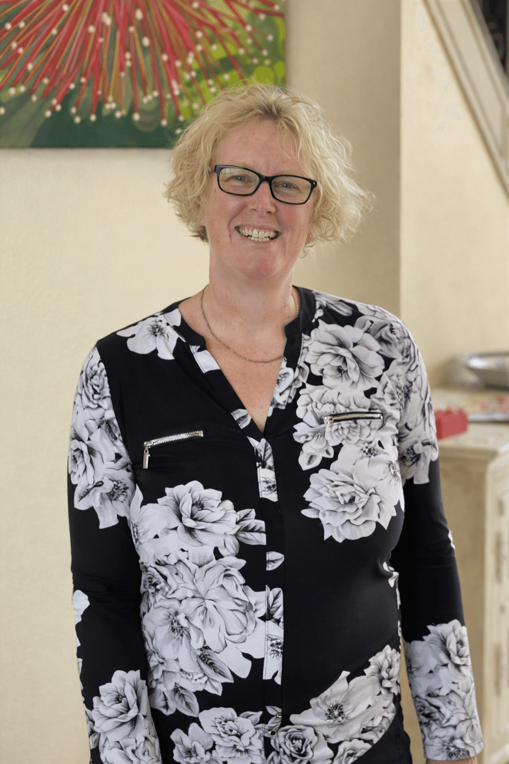 Black and white portrait of a smiling person with curly hair