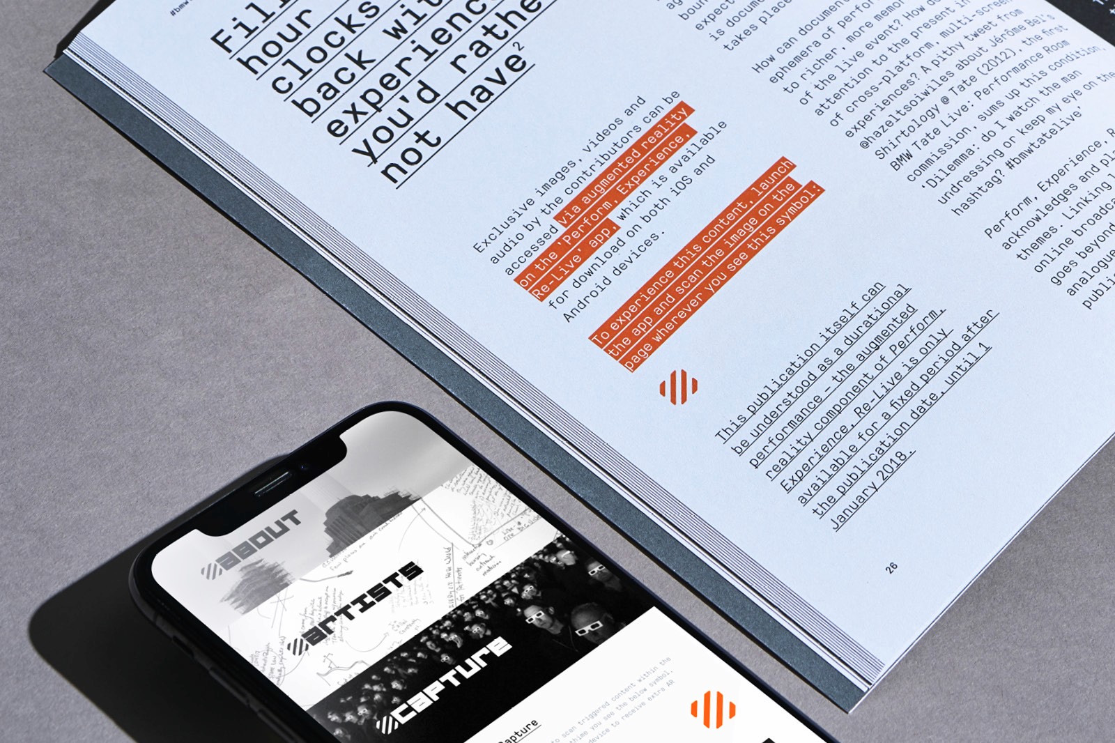 A smartphone displayed alongside an open magazine featuring graphs and text on a flat surface.