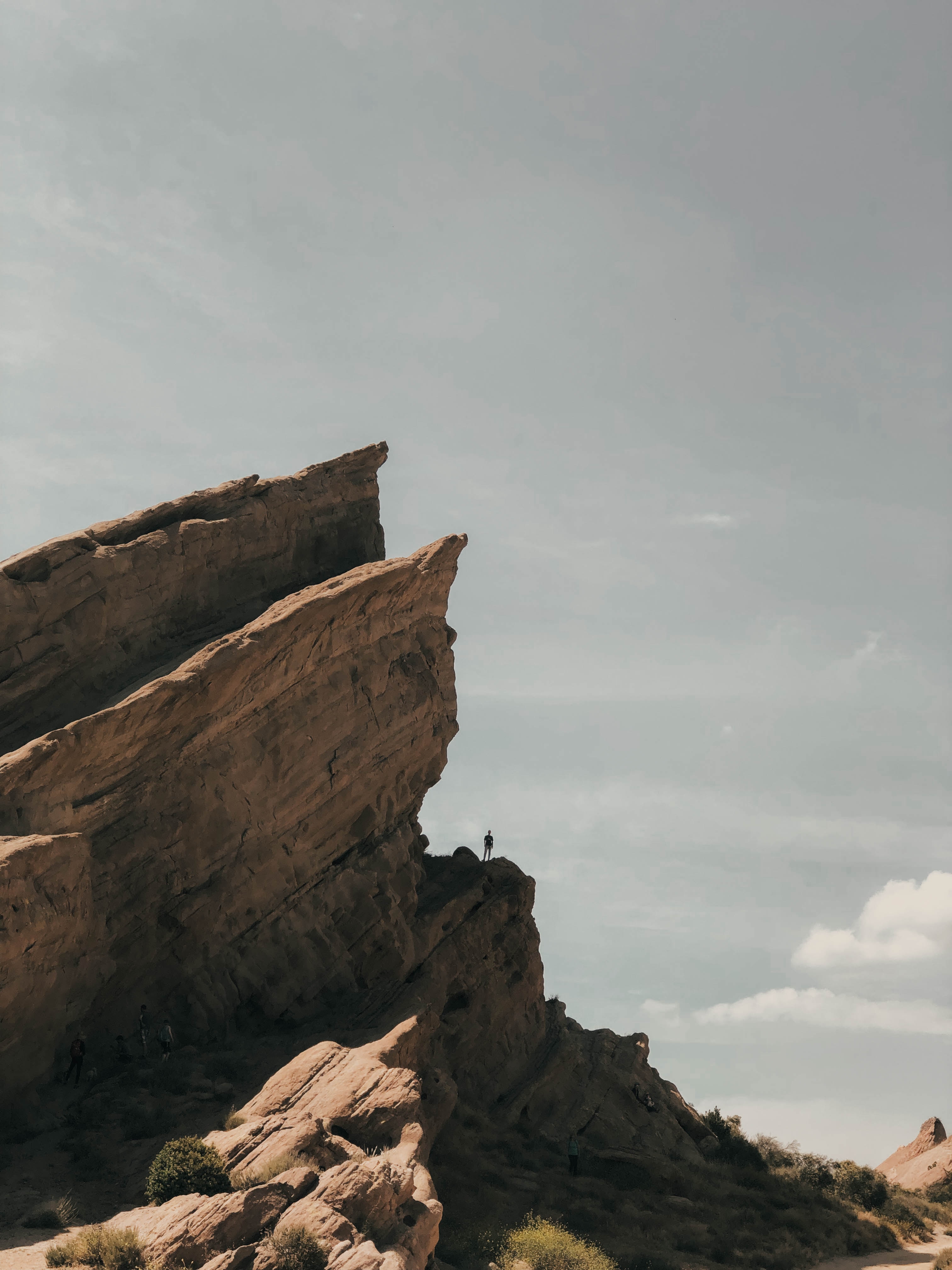 Cliffside with climber at the base