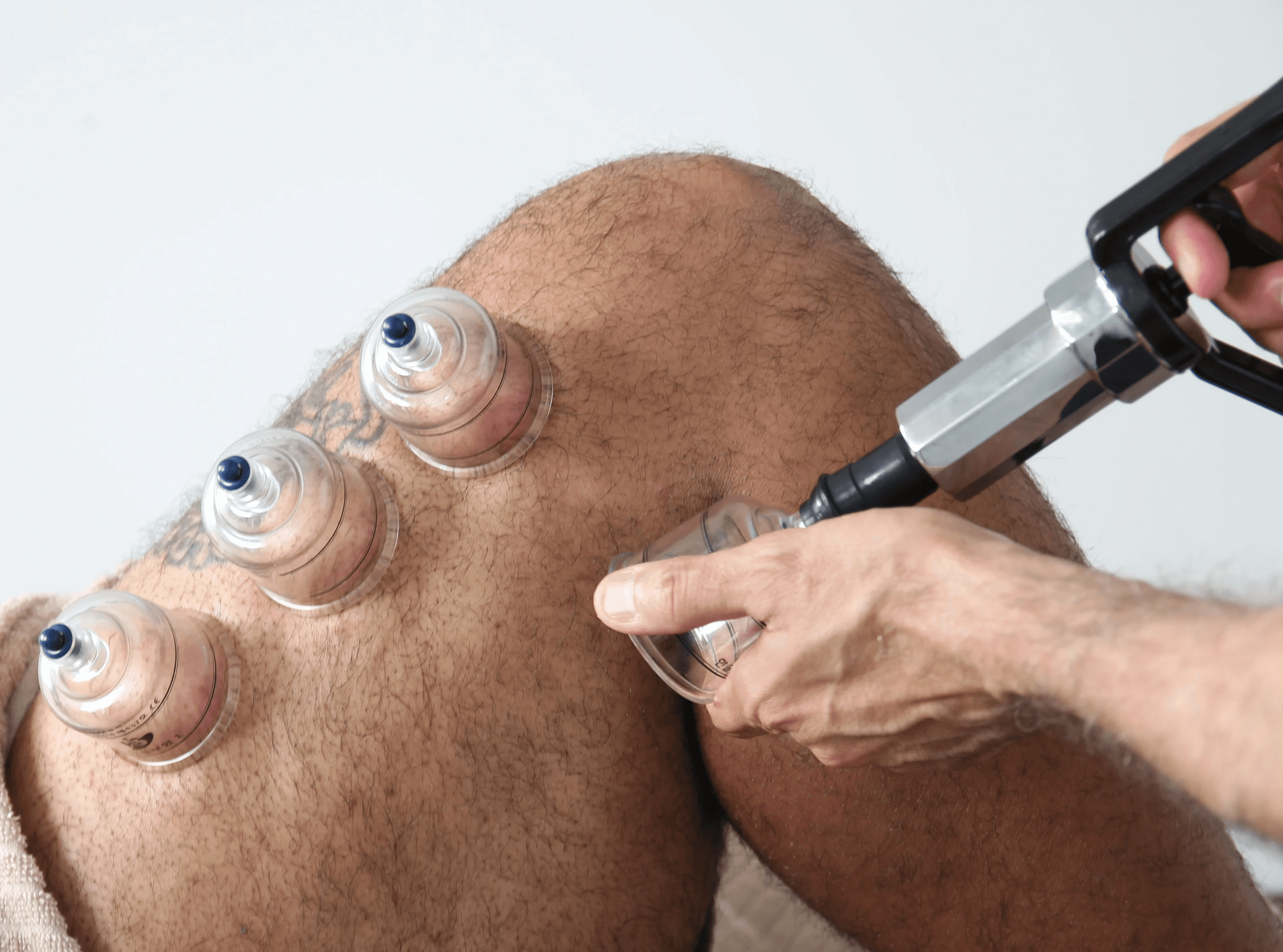 Woman lying down with a white facial mask being applied, surrounded by a calming spa environment