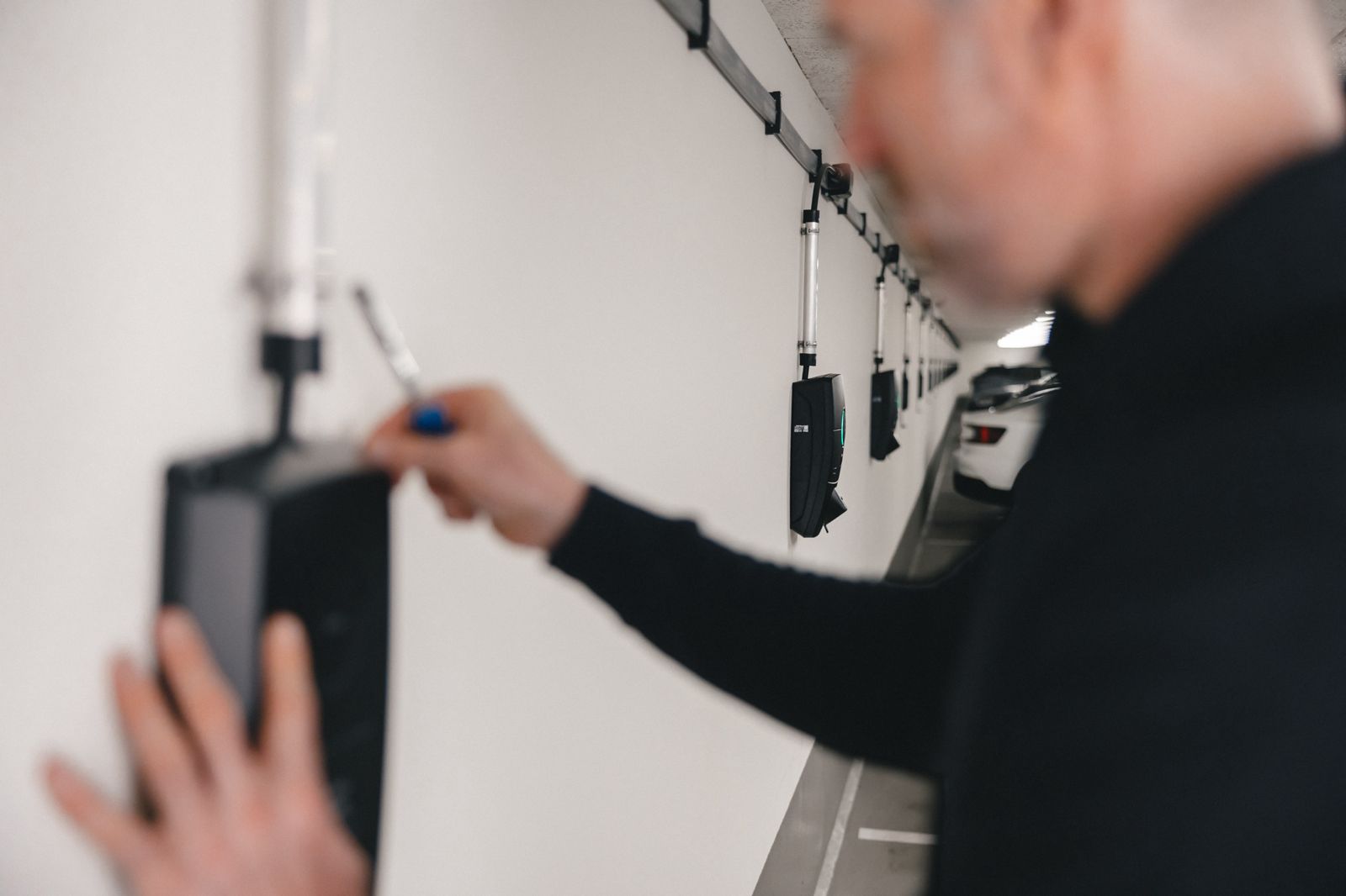 a person is plugging in to a wall mounted device
