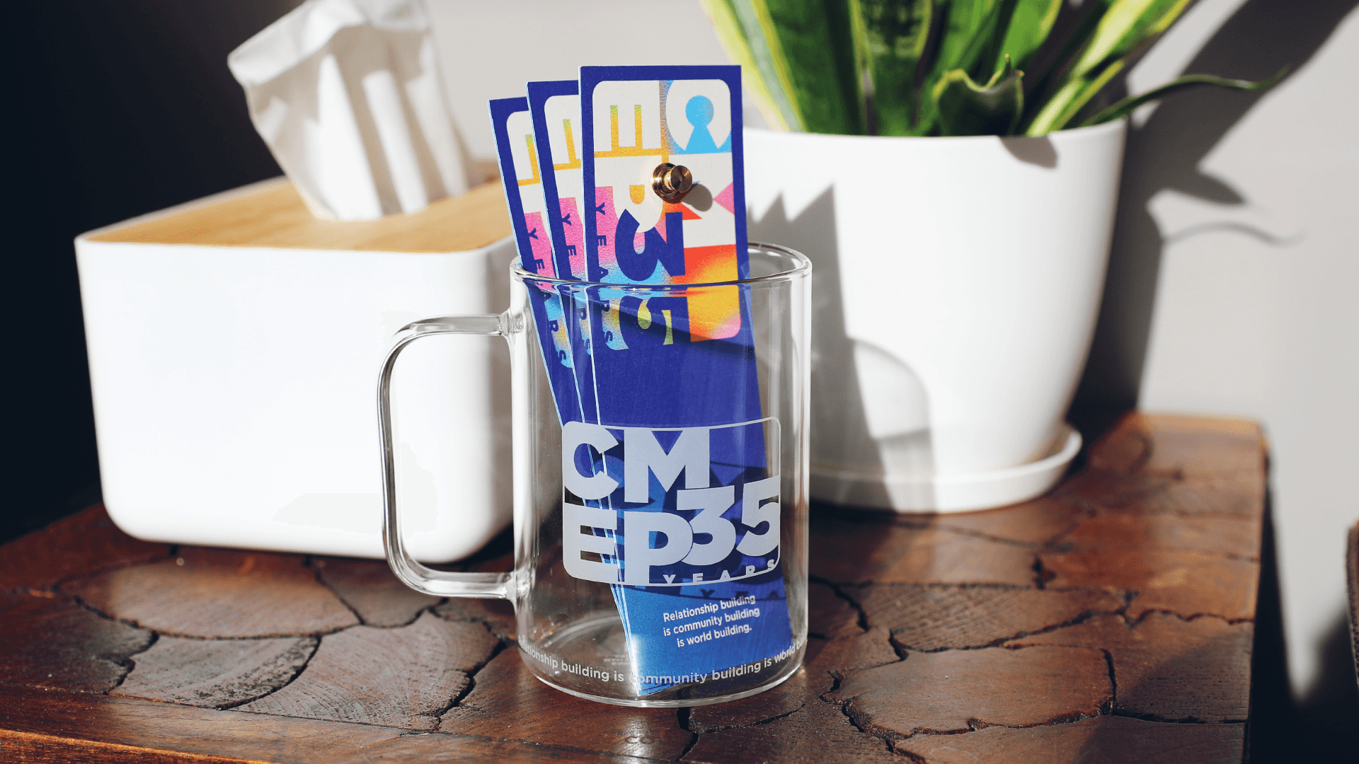 CMEP 35th Custom Bookmarks and Enamel Pins  inside a Custom CMEP 35th Glass Mug