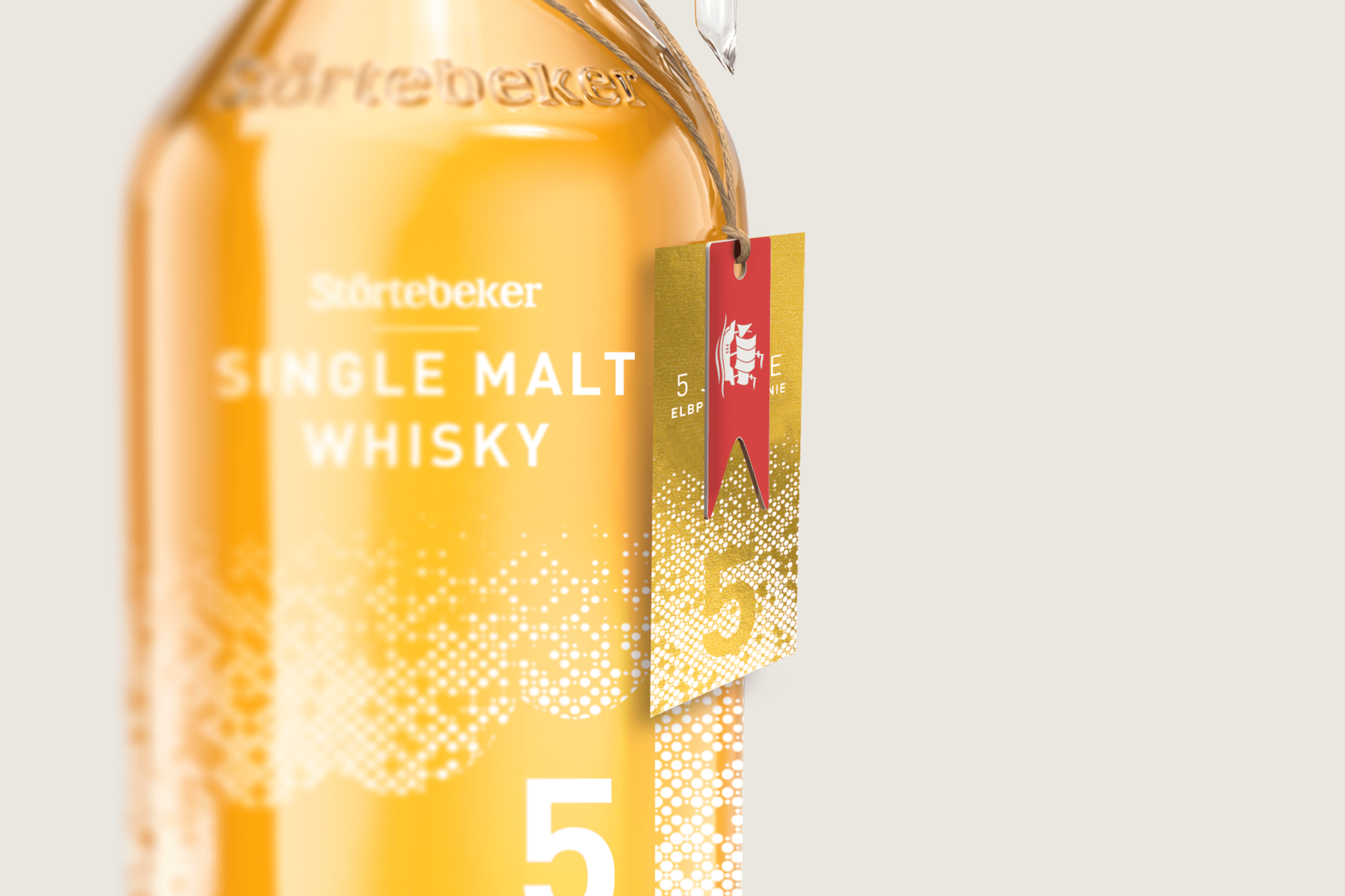 Störtebeker single malt whisky bottle with a red and gold tag