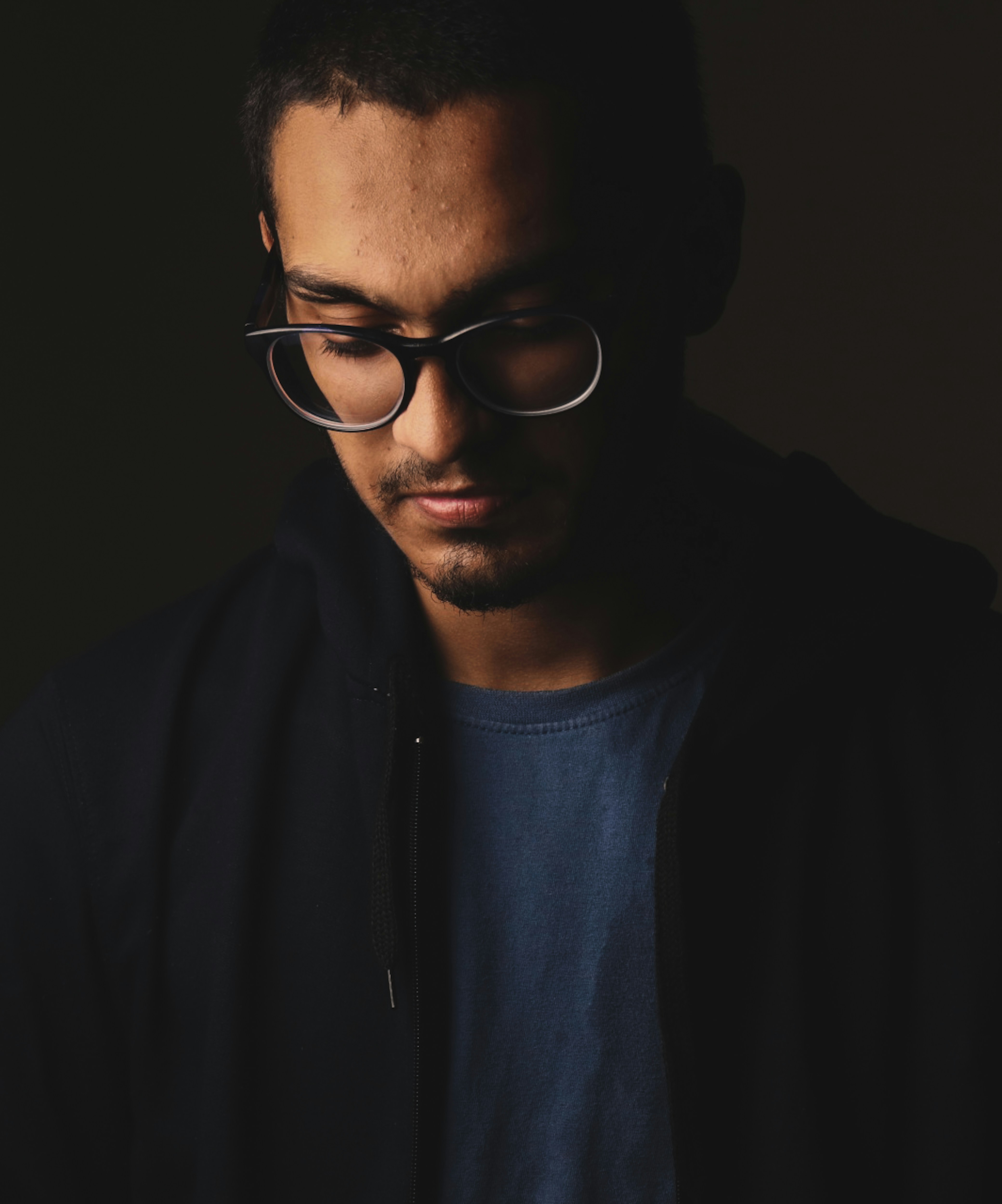 man in black jacket wearing black framed eyeglasses