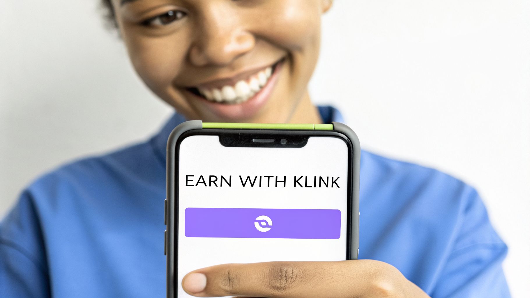 Smiling person holding a smartphone displaying 'EARN WITH KLINK' on its screen with a purple button.