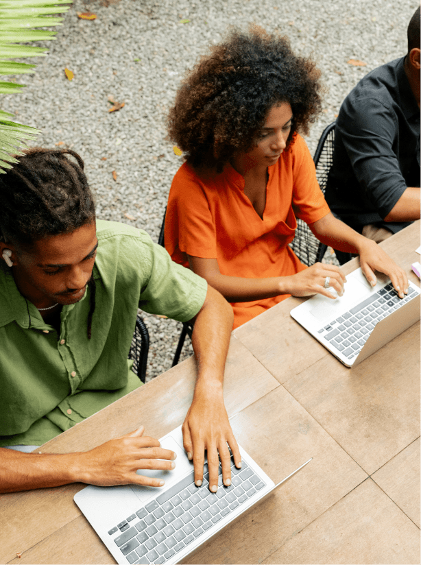 Three young people working on their laptops