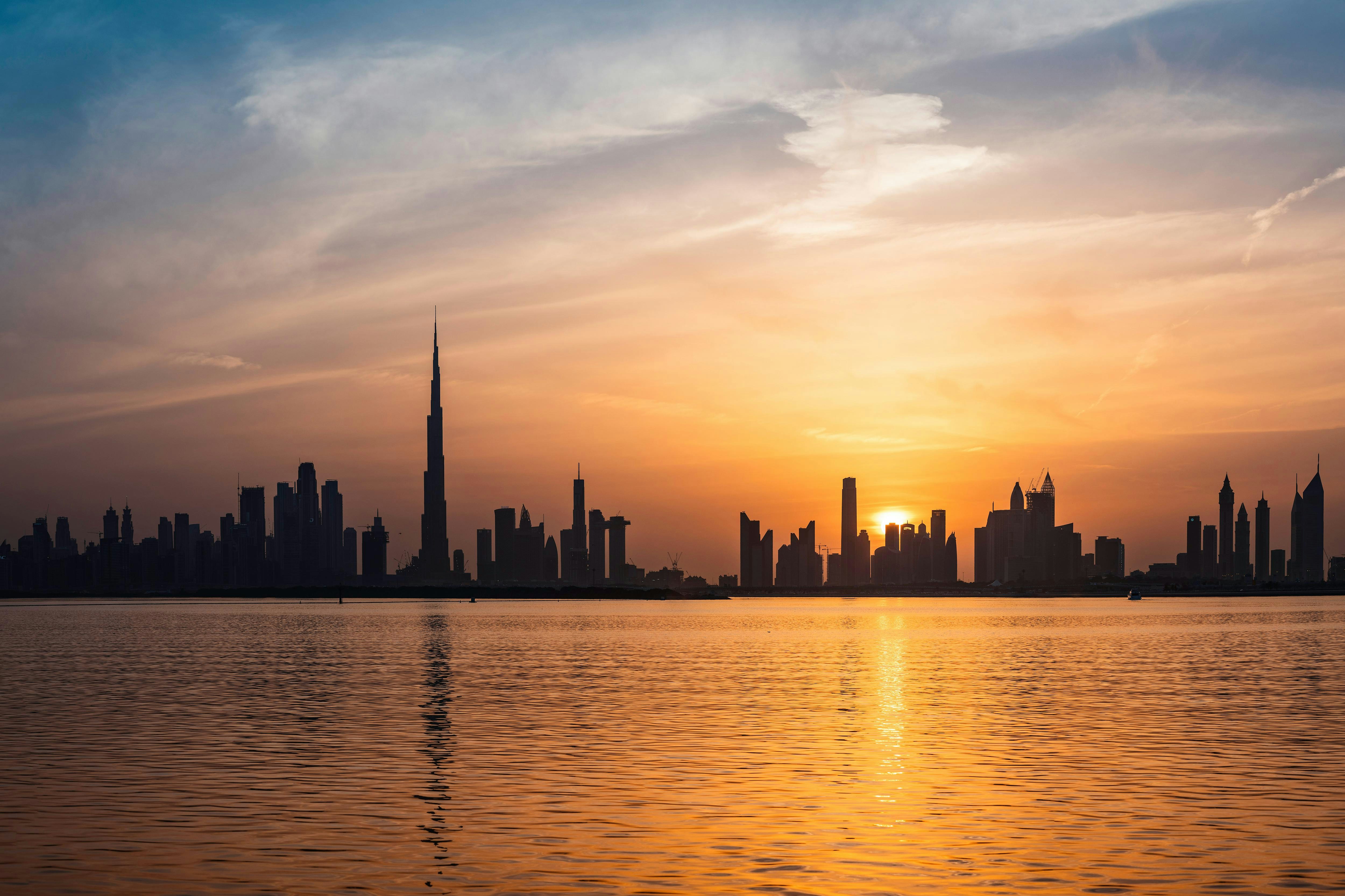 The sun is setting over the city skyline